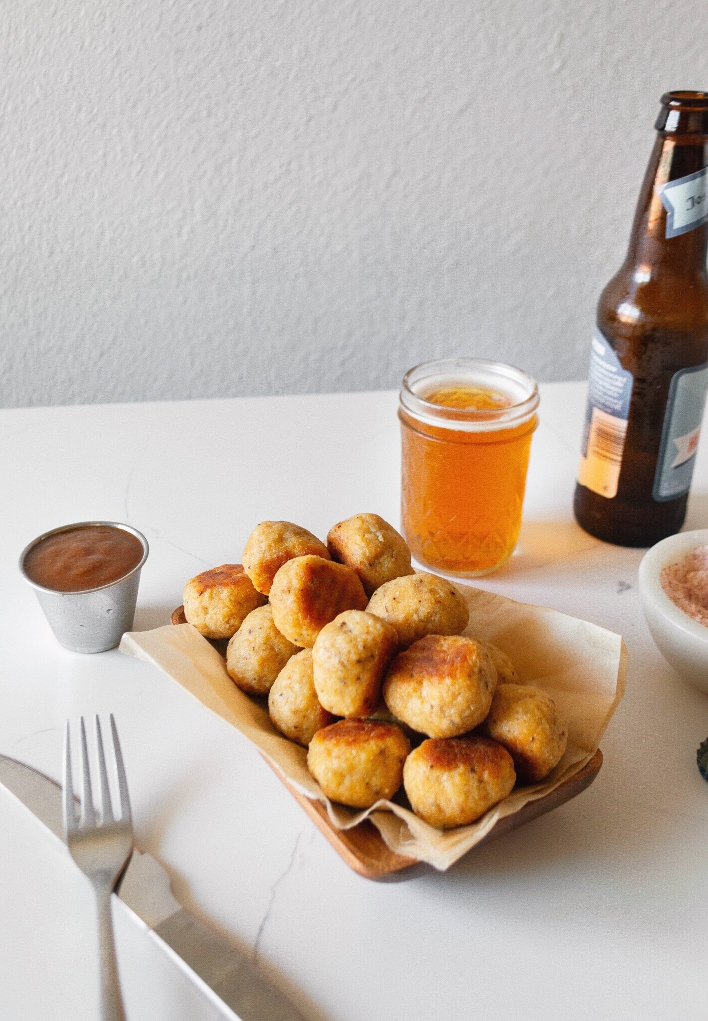 Plated Juicy Oven-Baked Chicken Meatballs with a beer and dipping sauce