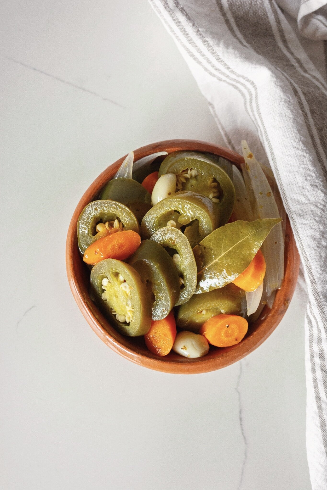 Storing the homemade escabeche in a glass container