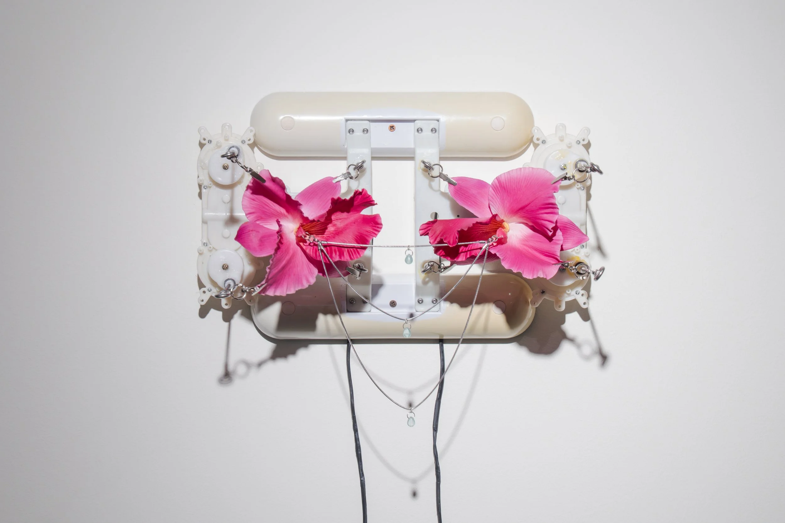 Rachel Youn,  The Agony of Love,  2026, modified back massagers, artificial orchids, hardware, snake chain, glass, plastic, 11¾ x 18½ x 9½ in.
