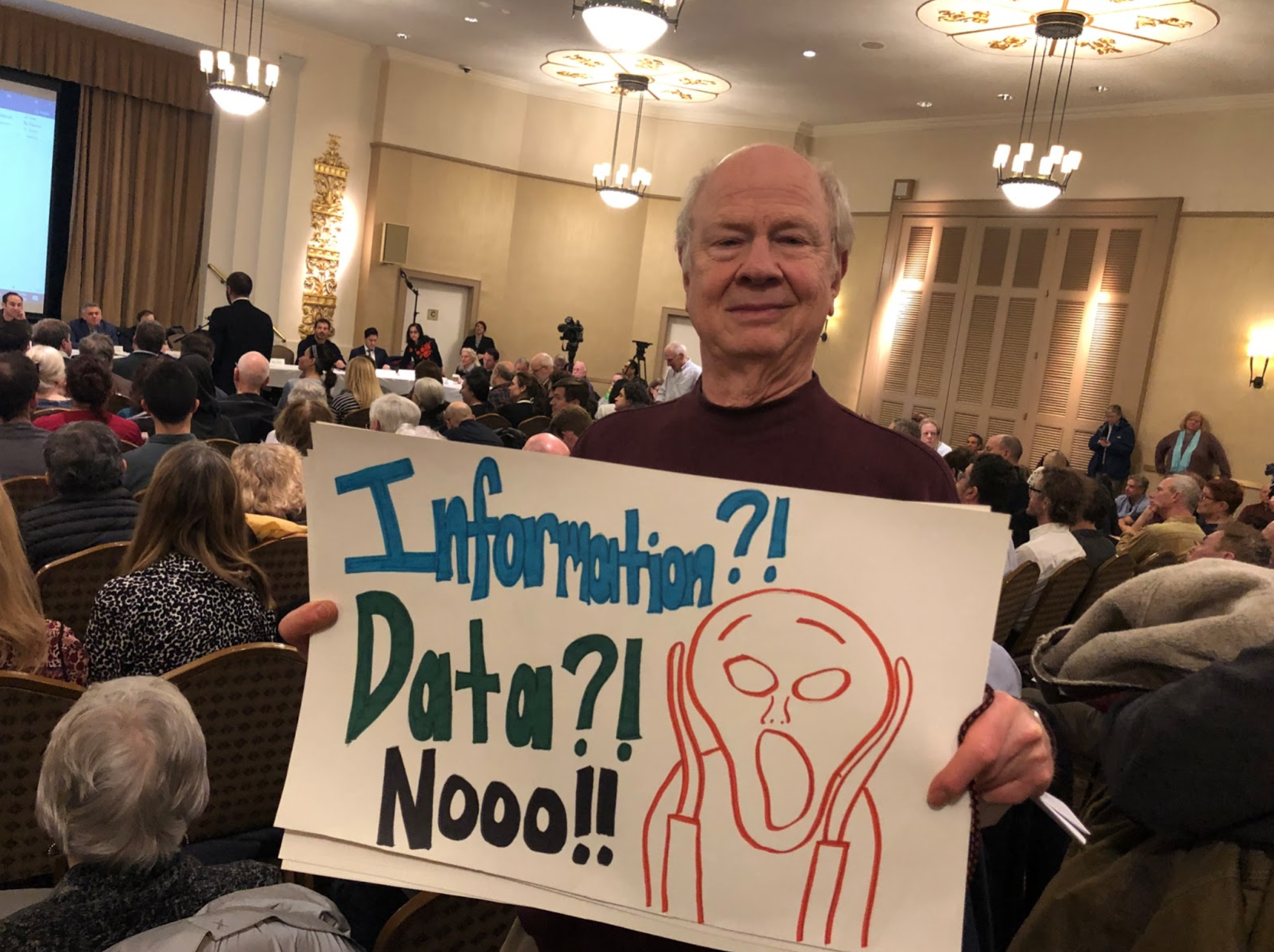 StreetopiaUWS packed a Community Board 7 meeting with proponents of a study of the curbside (it passed). Peter Frishauf holding sign. February 2020. 