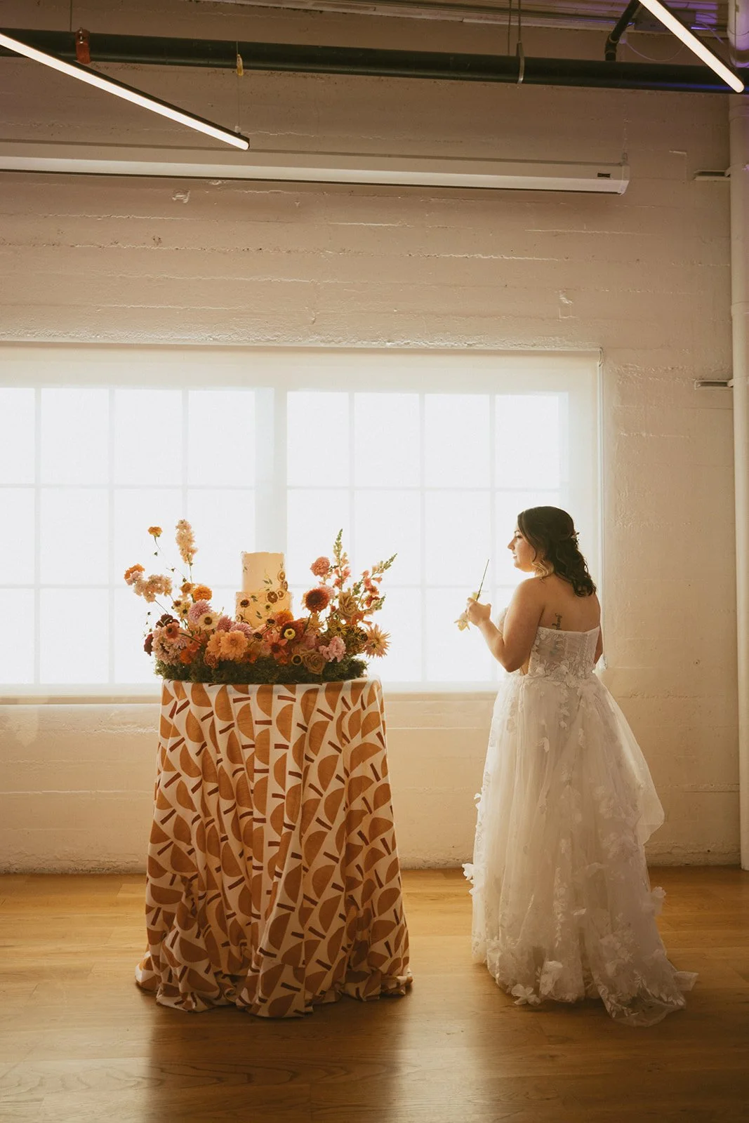 Fall Wedding Reception - Bride Enjoying Cake Flowers.jpg