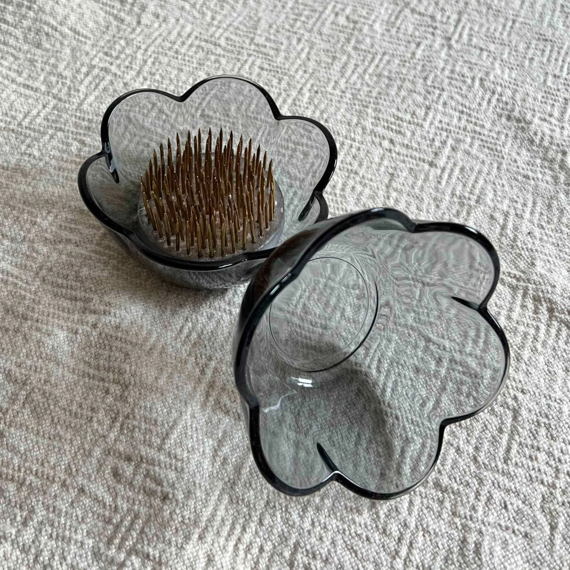 Two small dark blue glass colored ikebana pin frog cups.