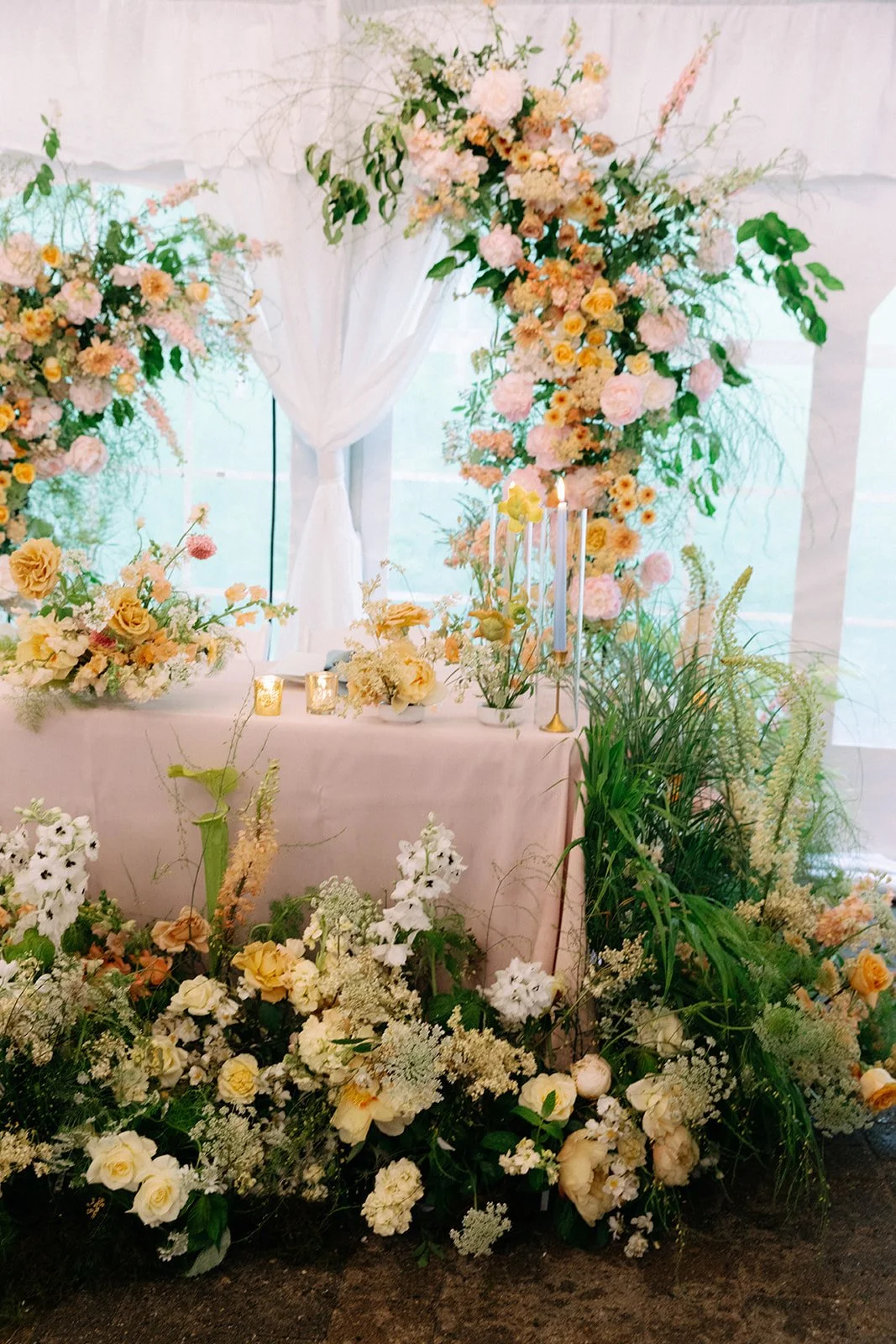Grassy Elegant Wedding Florals Surrounding Sweetheart Table.jpg
