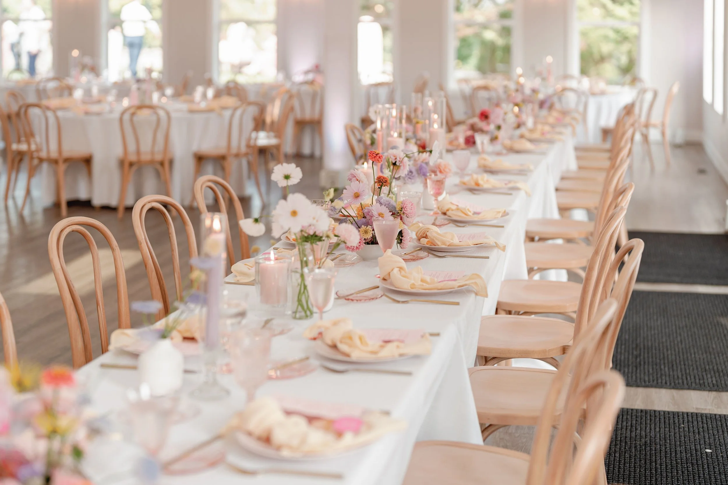 Wedding Reception Tables with Pastel Floral Centerpieces.jpeg