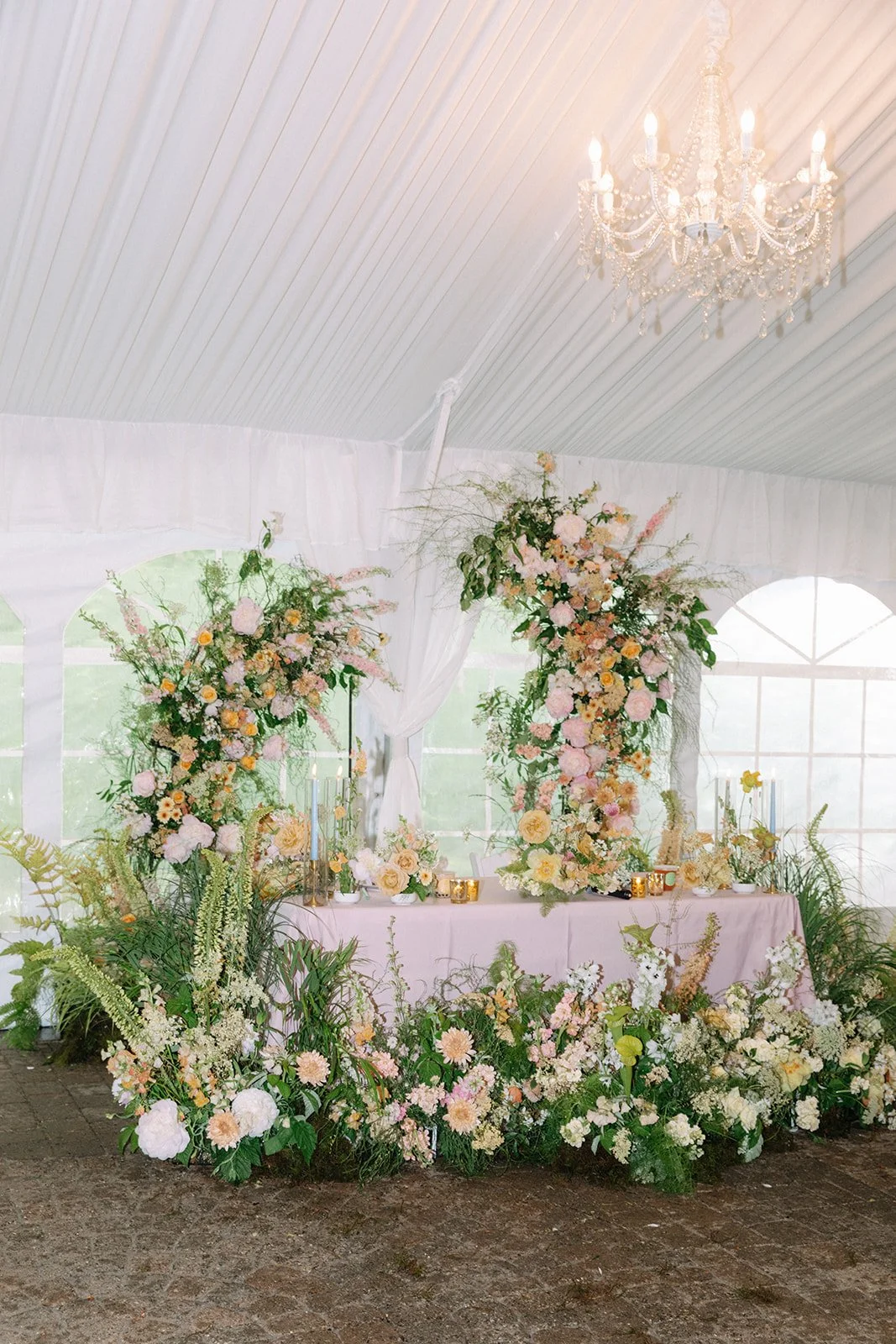 Sweetheart Table Surrounded with Grassy Grounded Floral Arrangements.jpg