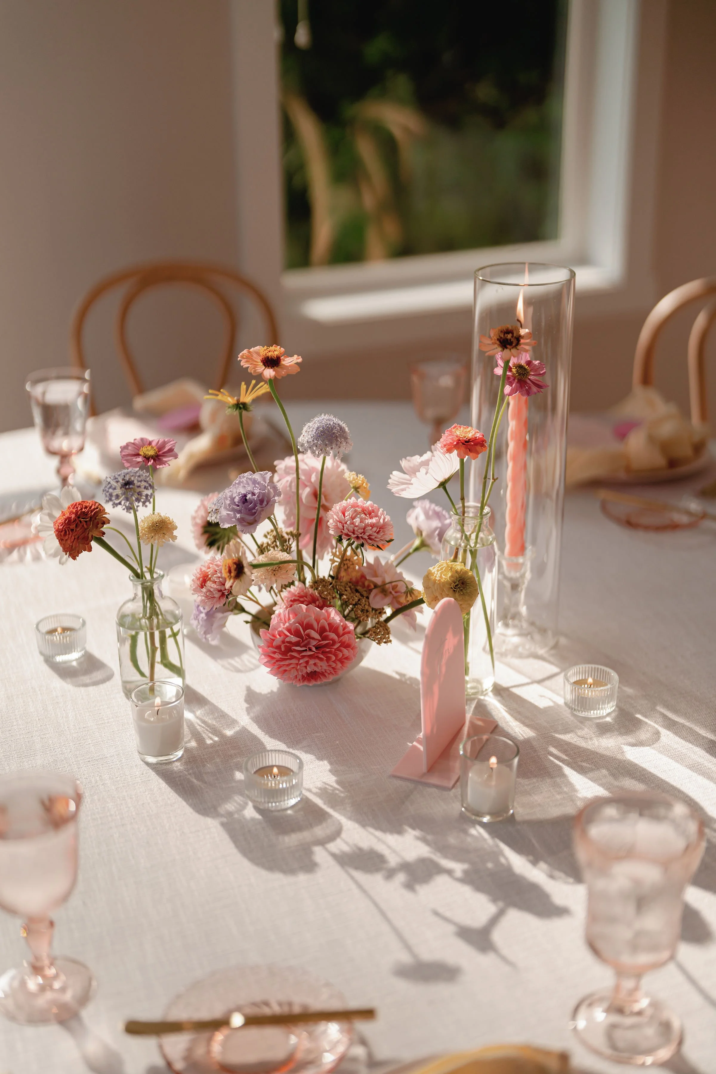 Pastel Wedding Reception Floral Centerpiece with Taper Candles.jpeg