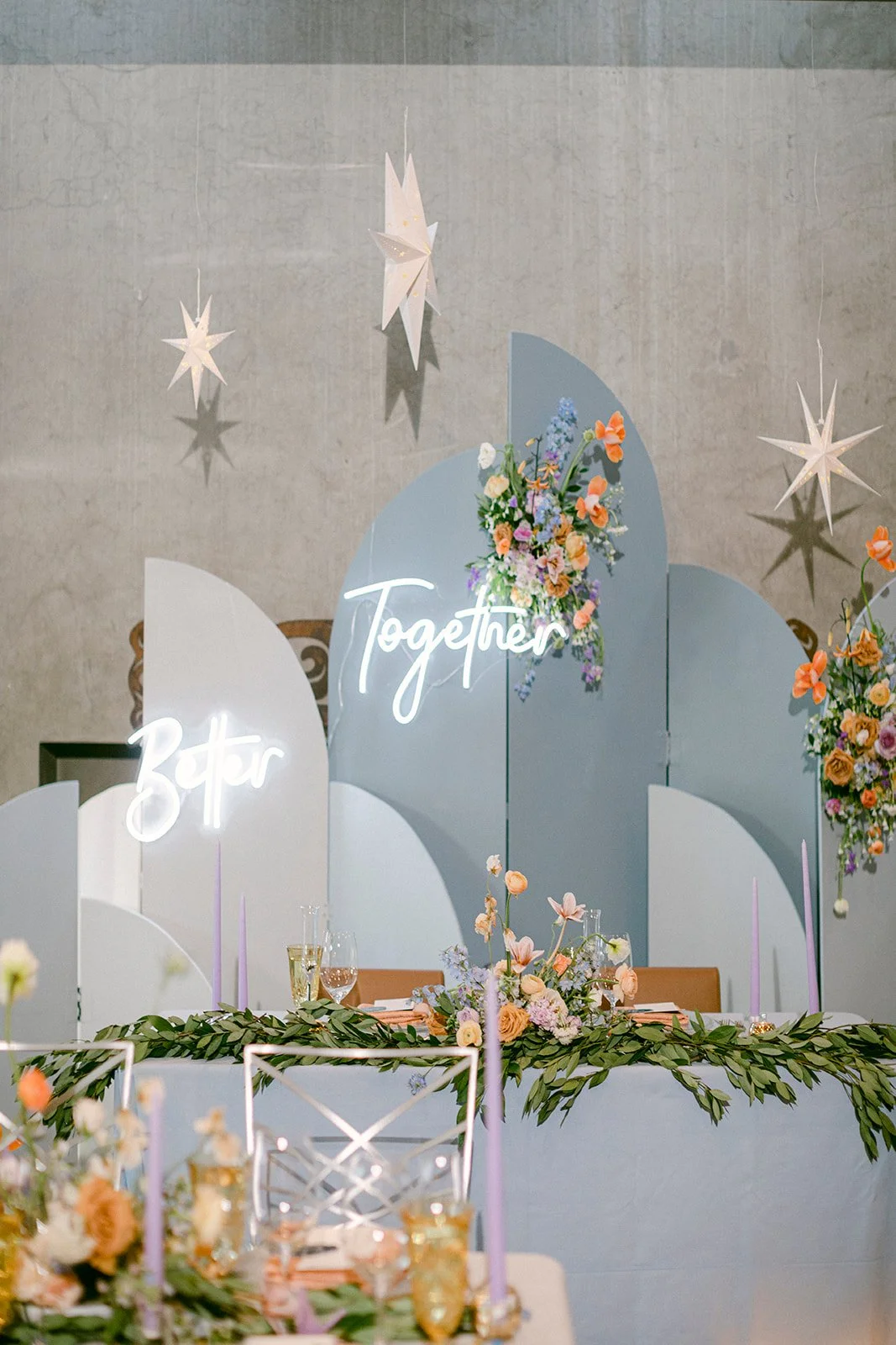 Pastel Blue Sweetheart Table Backdrop with Bright Floral Installation.JPG