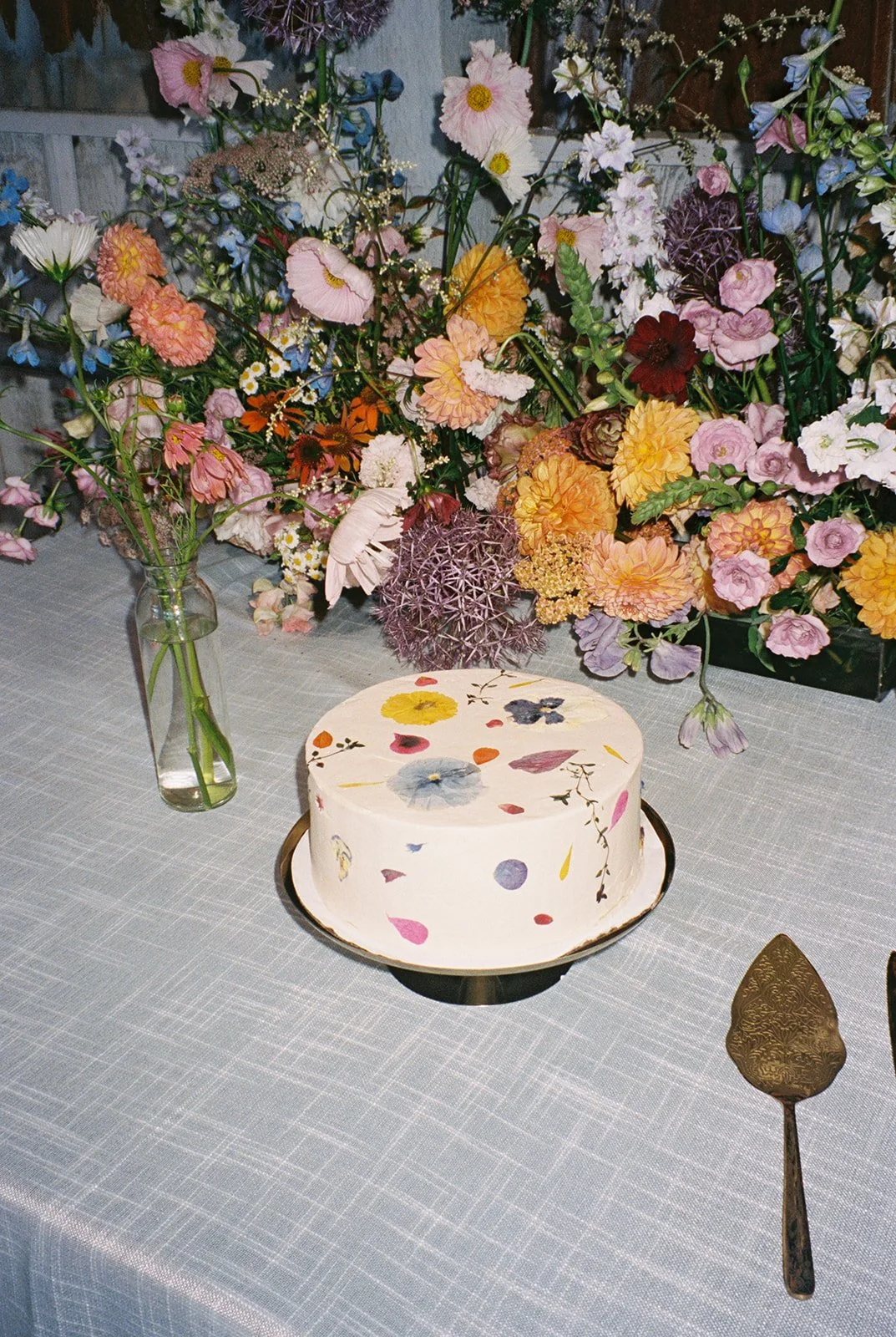 Pressed Floral Wedding Cake with Eclectic Floral Backdrop.jpeg