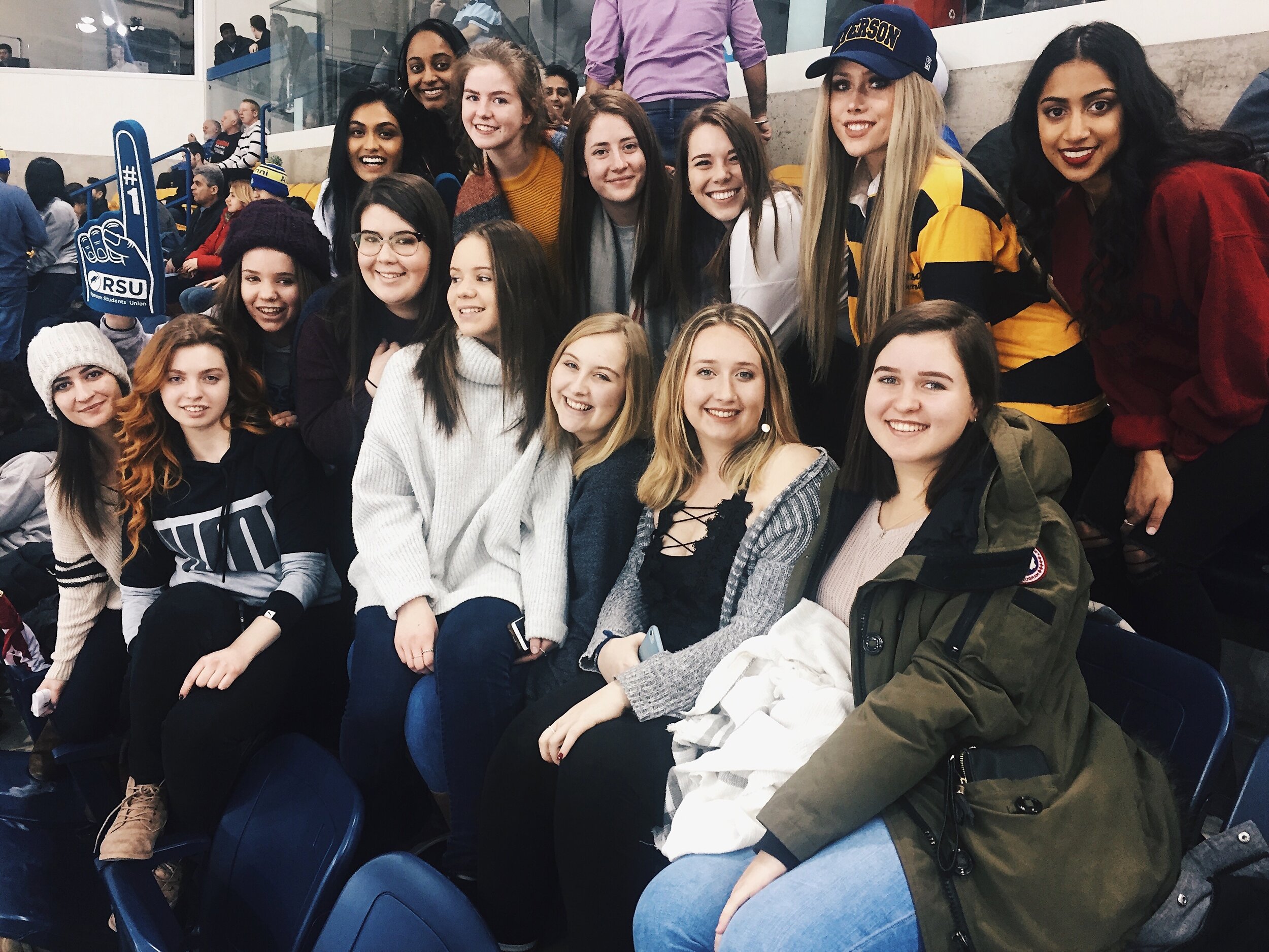 Sisters and potential new members at a Ryerson hockey game during rush period.