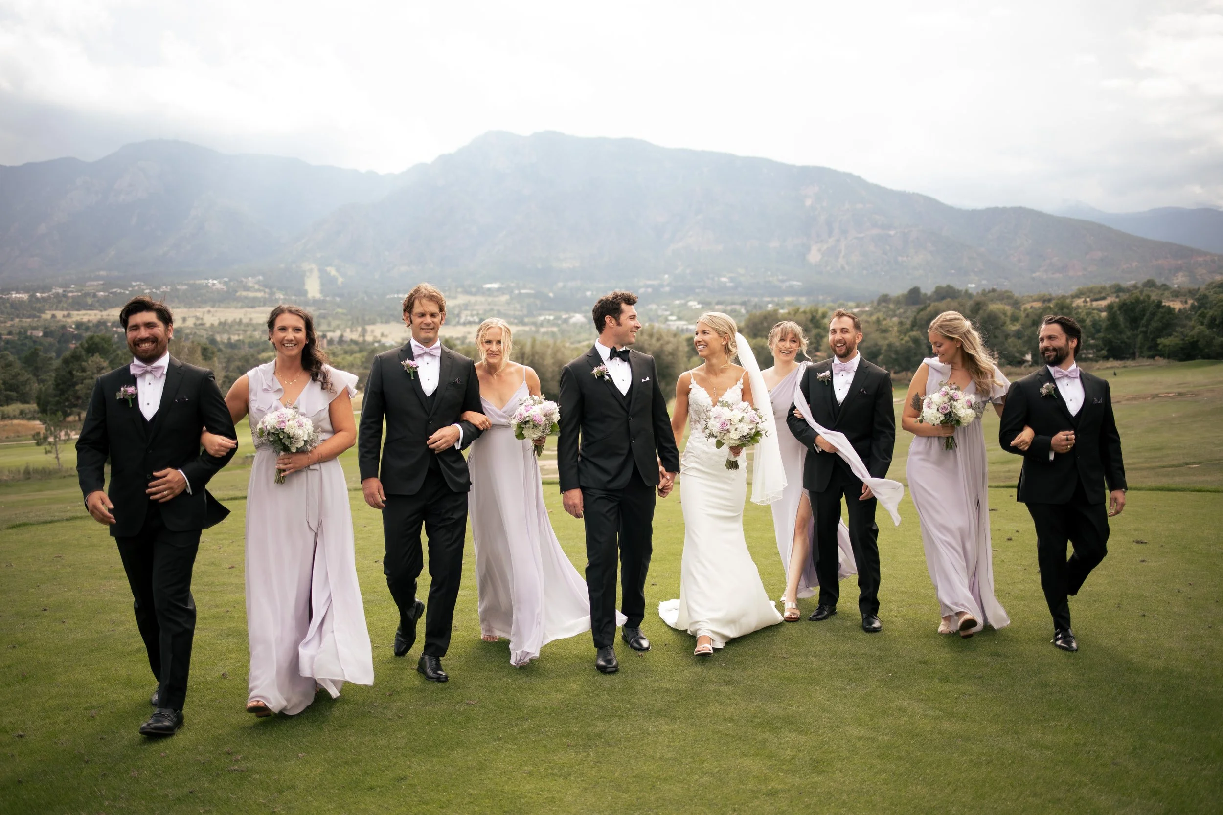 wedding party walking on green grass