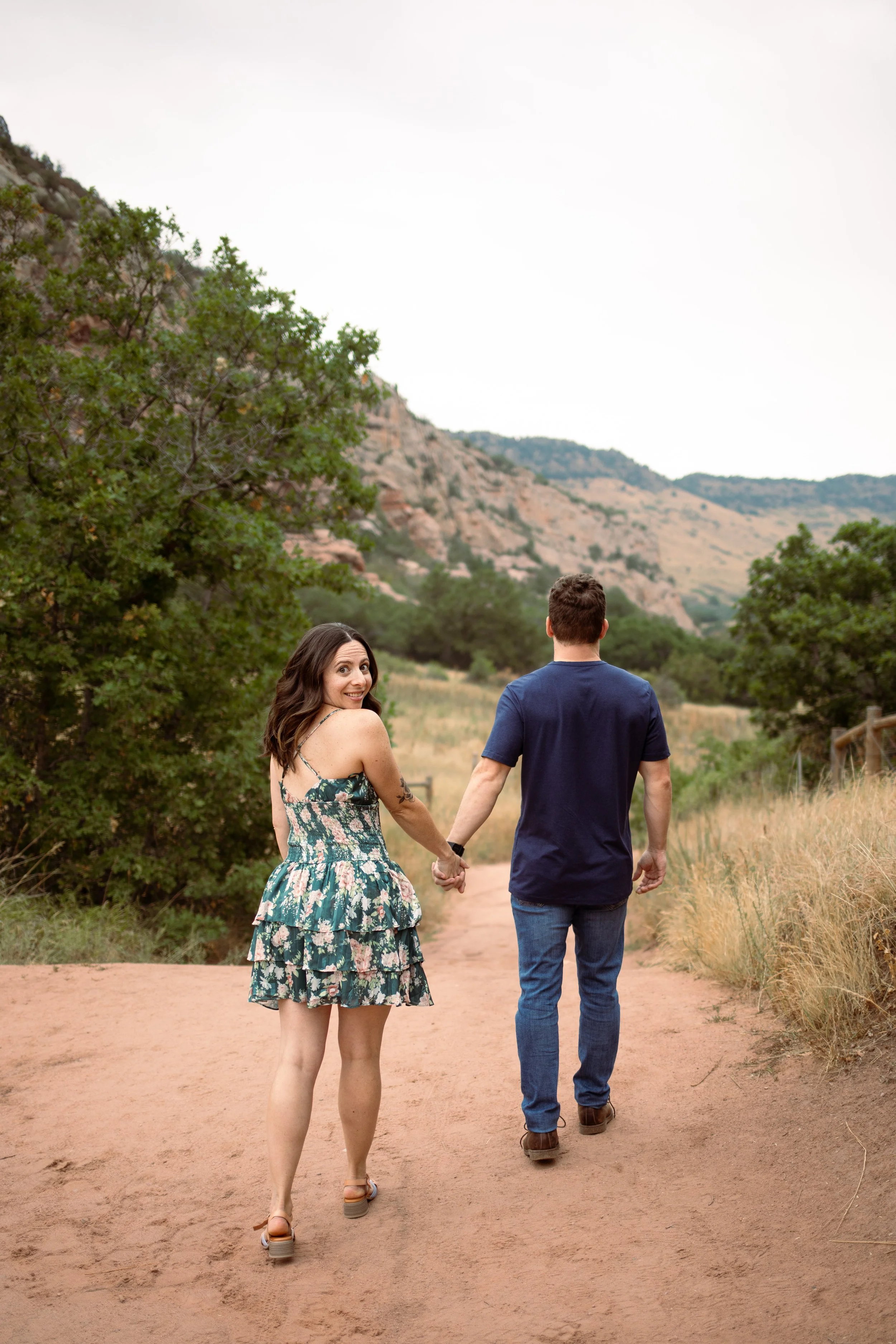 girl in dress walking with man