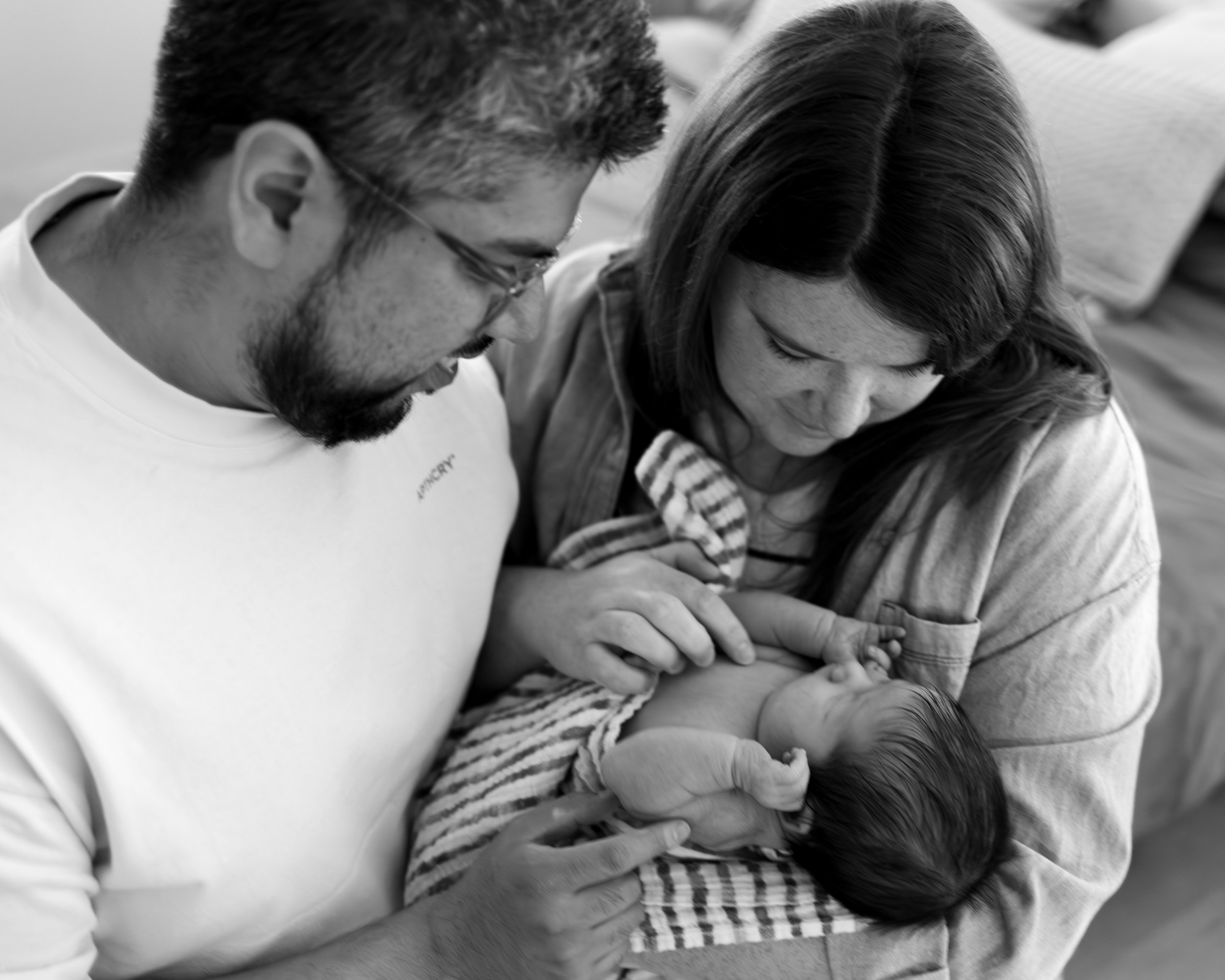 mother and father holding new born baby