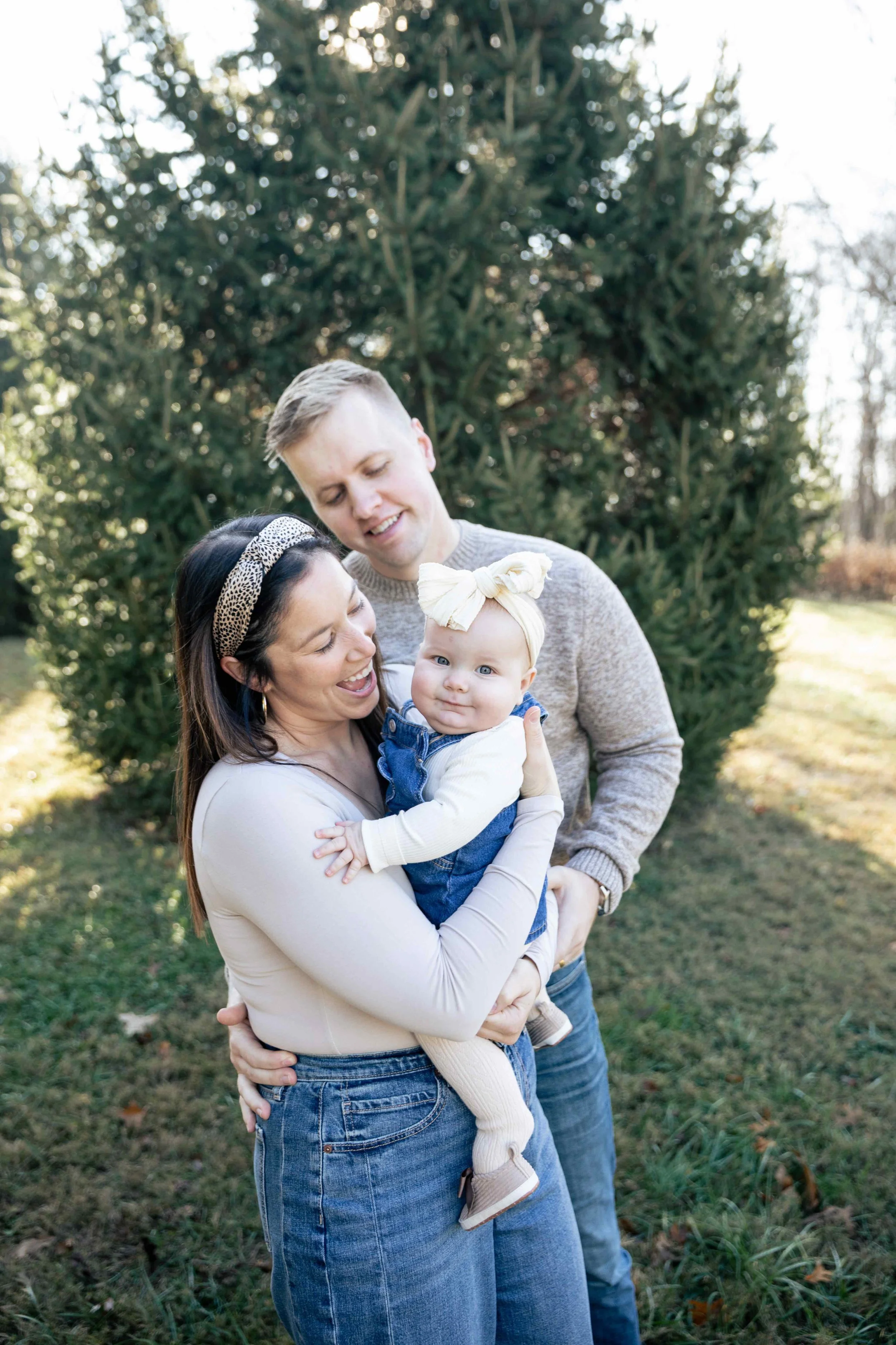 Mother daughter and father laughing outside together
