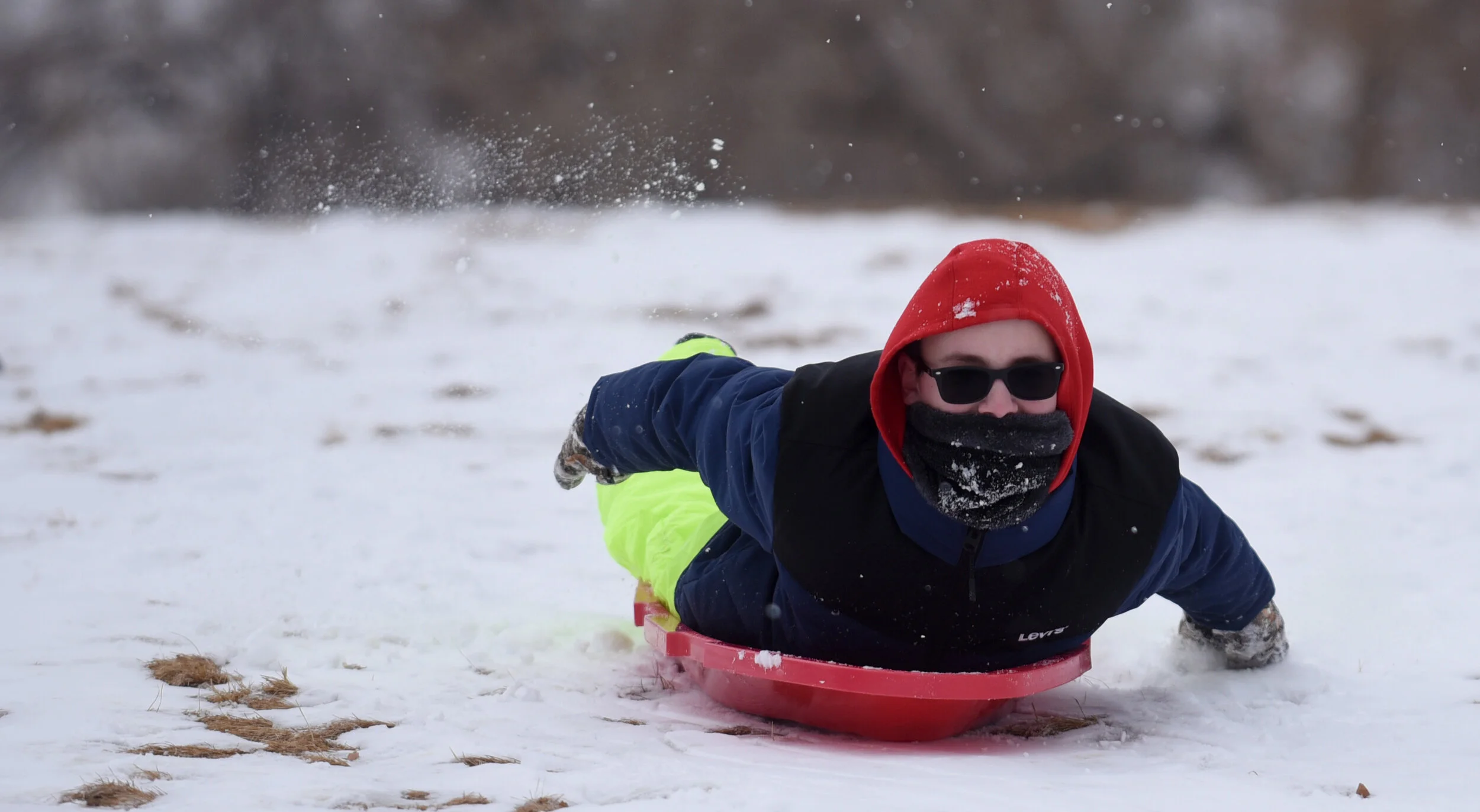 Jaiden Raney, 12, rushes down the sledding hill on the University of Northern Colorado campus in Greeley. Photo by Joshua Polson.