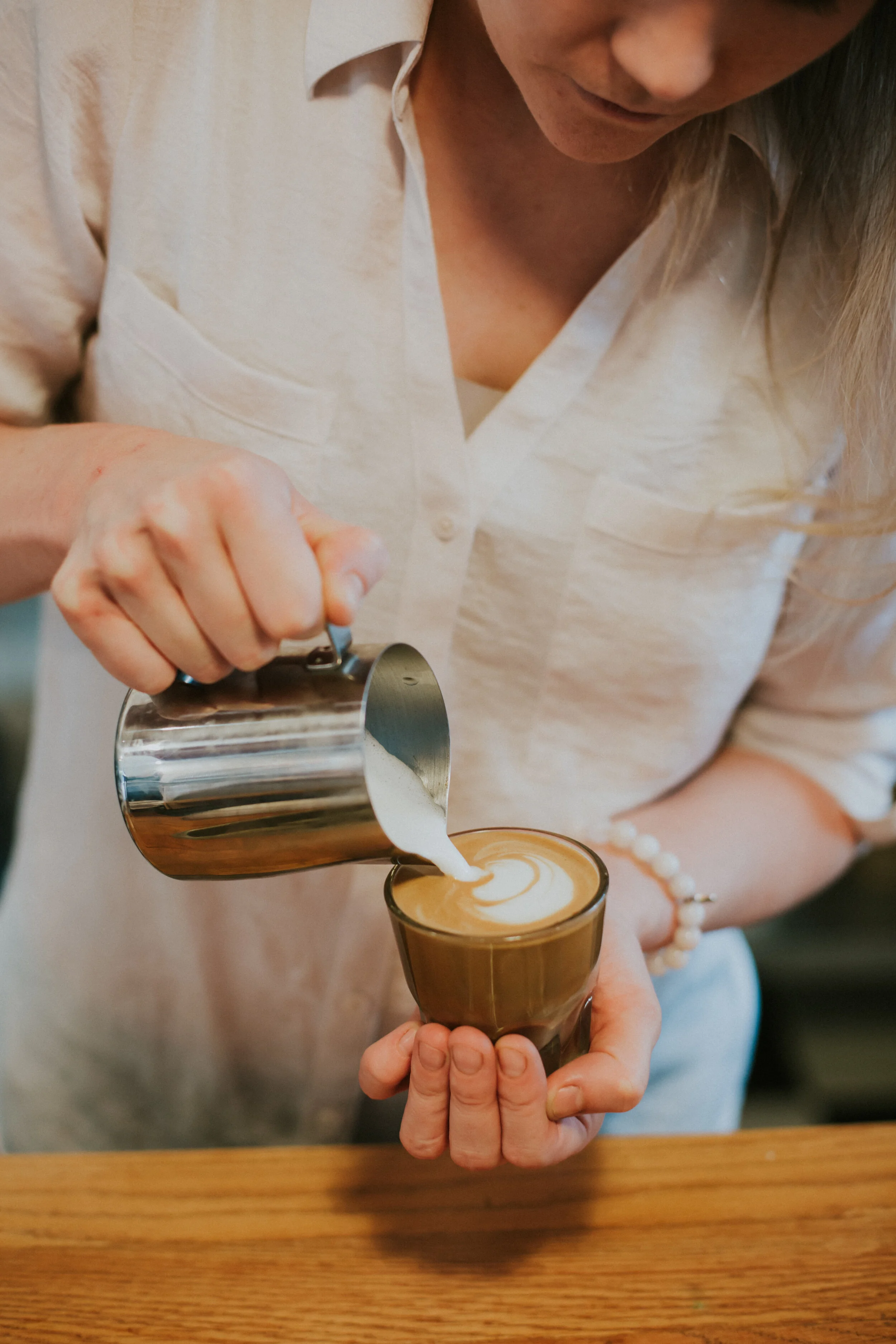 To create fancy latte art, milk is shot with hot steam in a metal carafe to froth it. The goal is to get a thick foam with tiny bubbles with the consistency of wet paint. Photo courtesy of Margie’s Java Joint.