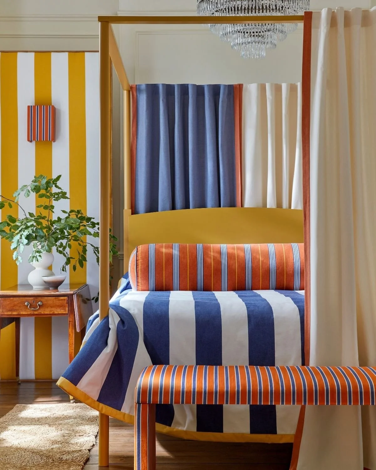 Ian Mankin Paint Pot Collection striped fabrics in a colourful bedroom with blue, orange and yellow accents.
