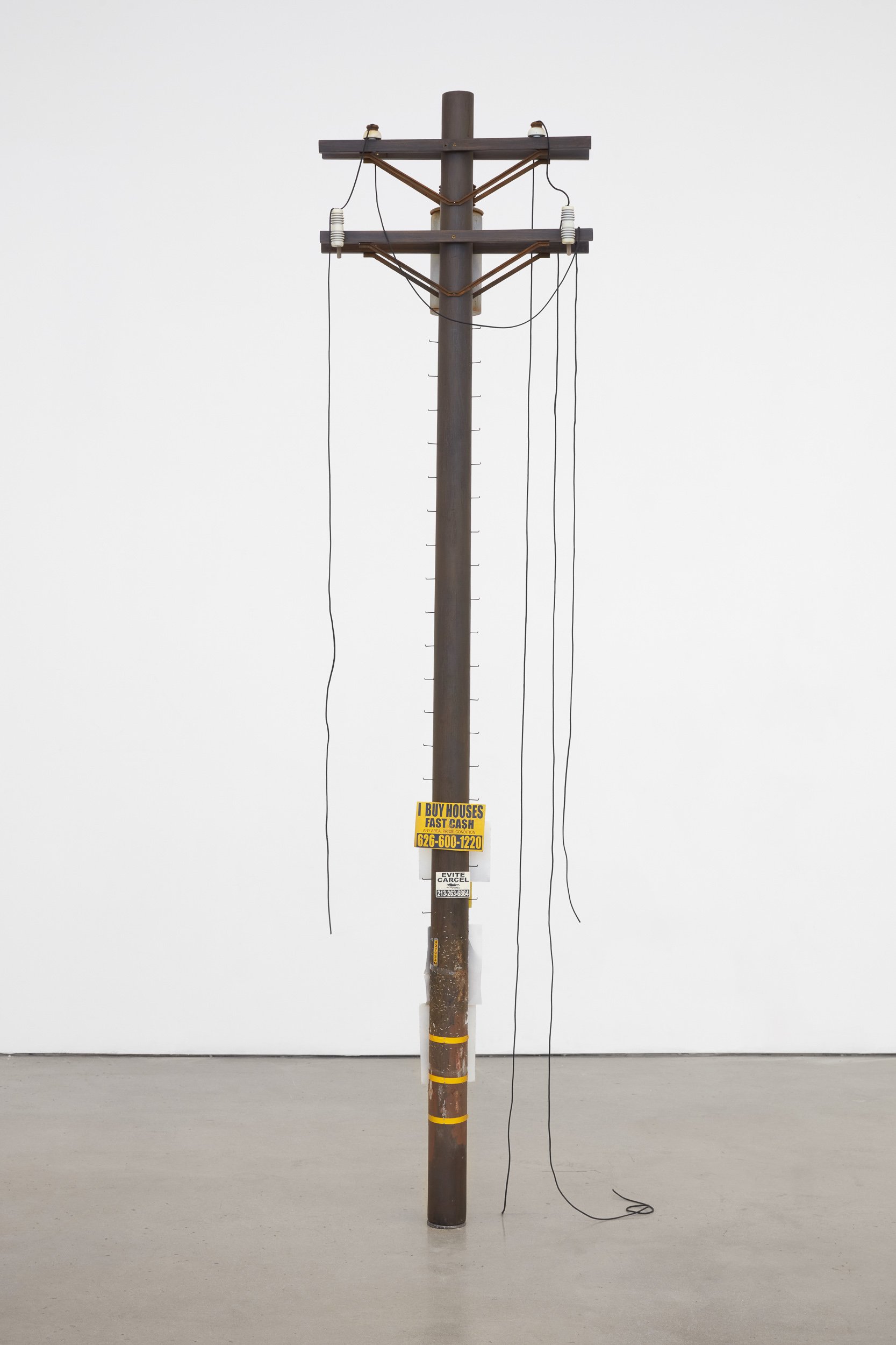   Totem,  2022. Bondo, acrylic and solvent based paints on wood, paper, steel, nylon shoelace, PVC, and vinyl. 96 x 23 x 10 inches 