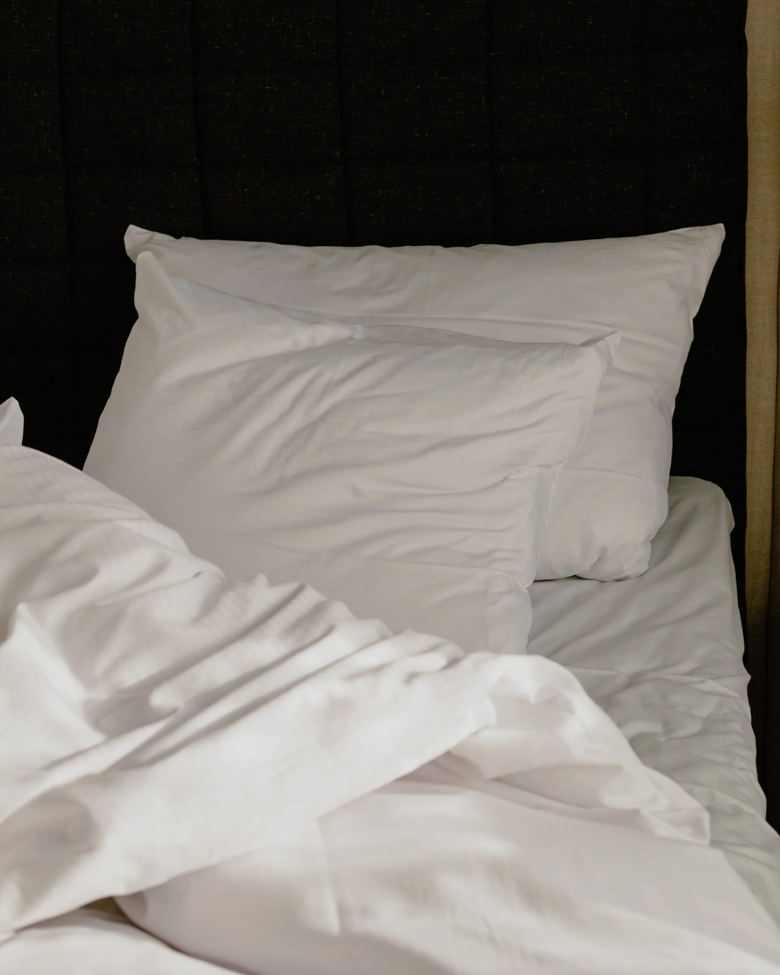 Very soft sheets in a bed with a simple bedframe. Nothing too fancy.