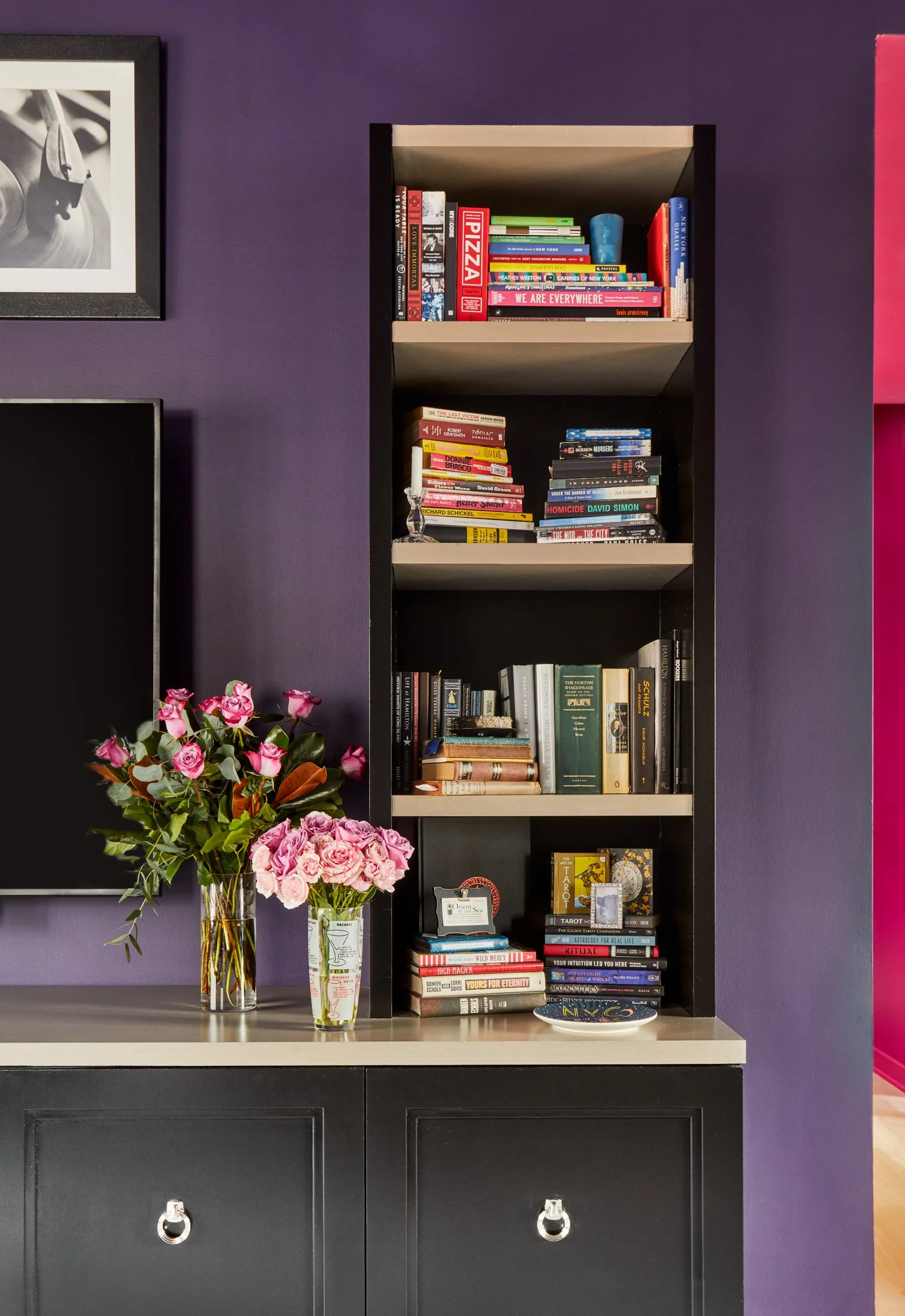 white custom built-ins get a color refresh with deep ebony high gloss paint, new hardware and color drenched walls in plum suit the clients' goth style