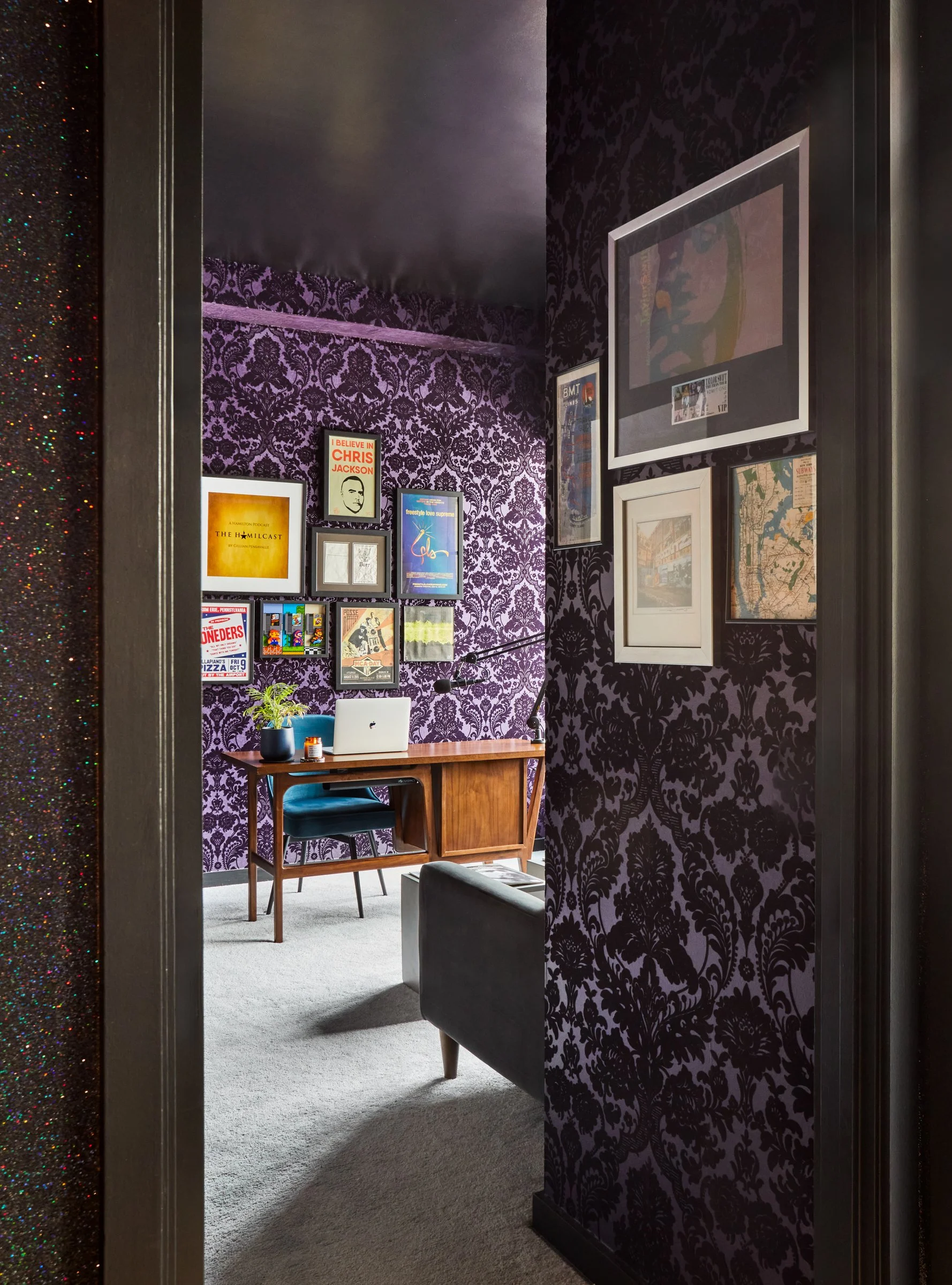 dramatic entrance to the home office papered in deep purple damask flocked wallpaper
