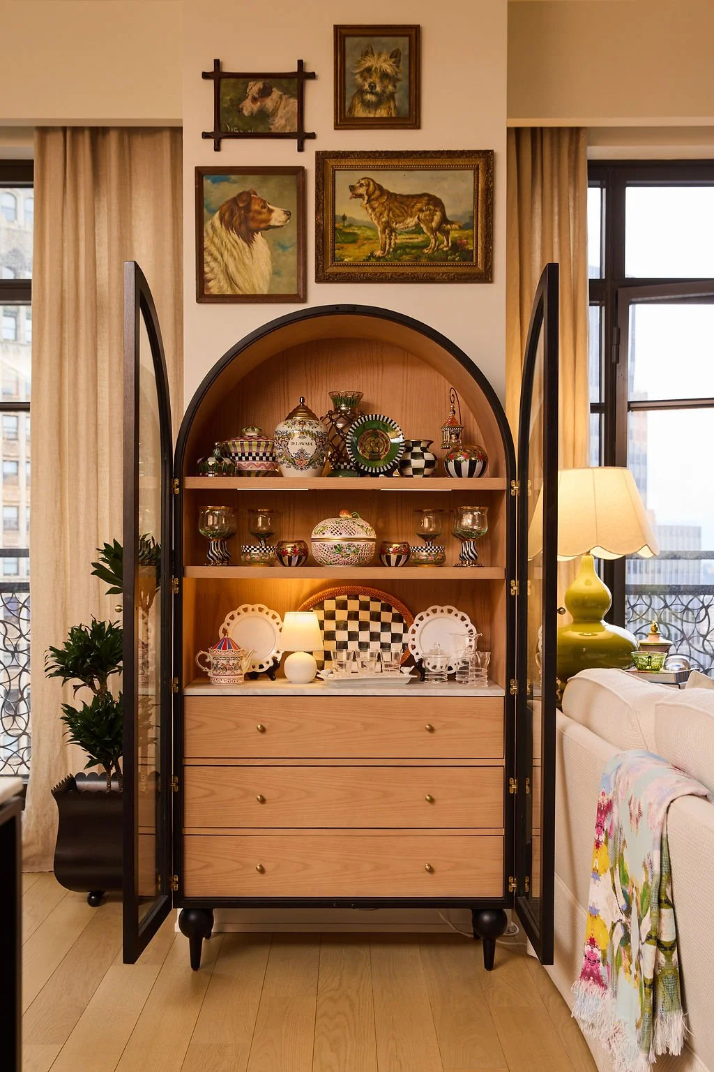collection of mackenzie child serving pieces in modern china cabinet