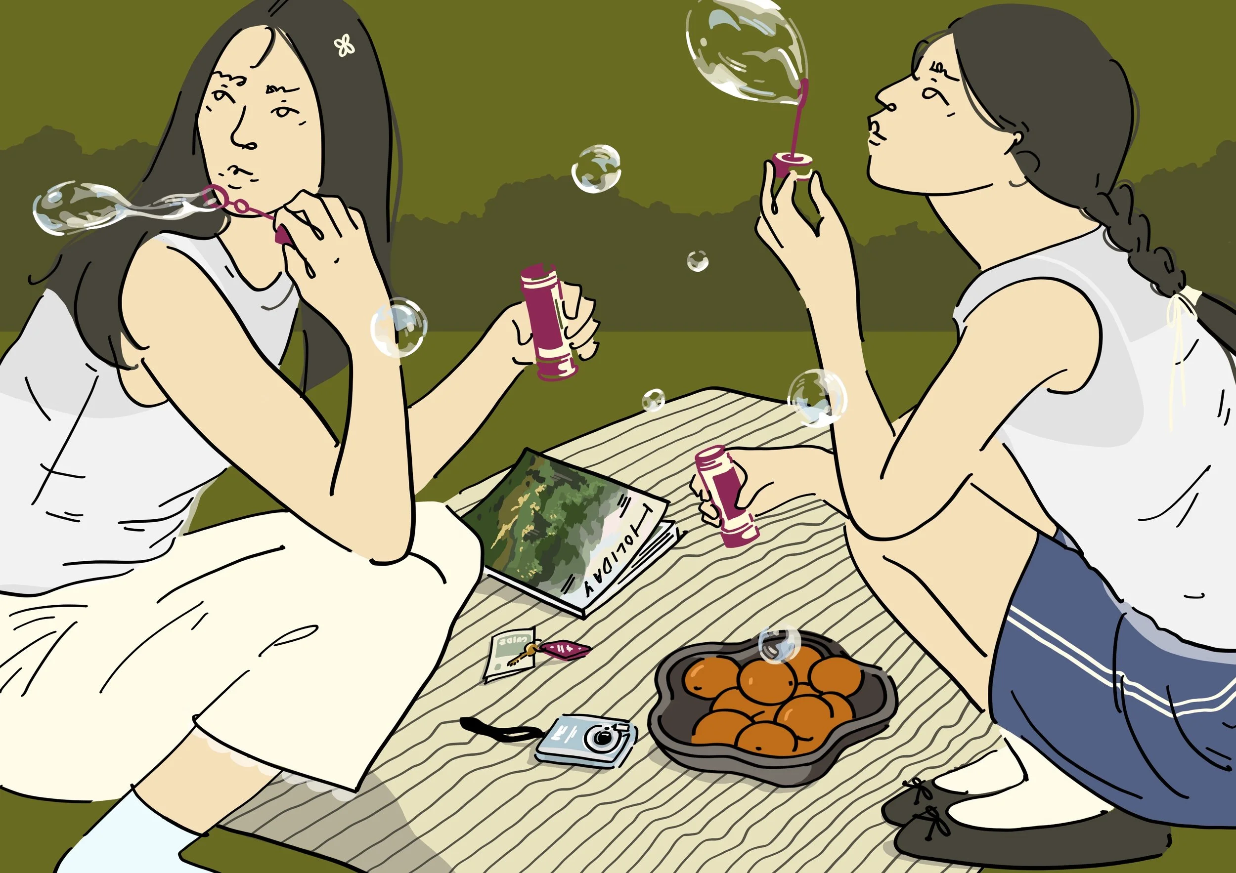 Two girls sitting on a blanket outdoors, blowing bubbles, surrounded by snacks and a camera, with a magazine titled 'YOUTH' on the blanket.