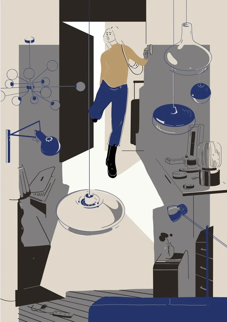 A woman with blonde hair wearing a beige sweater, blue jeans, and black boots, standing in a modern kitchen, leaning against the doorframe, holding a cup.