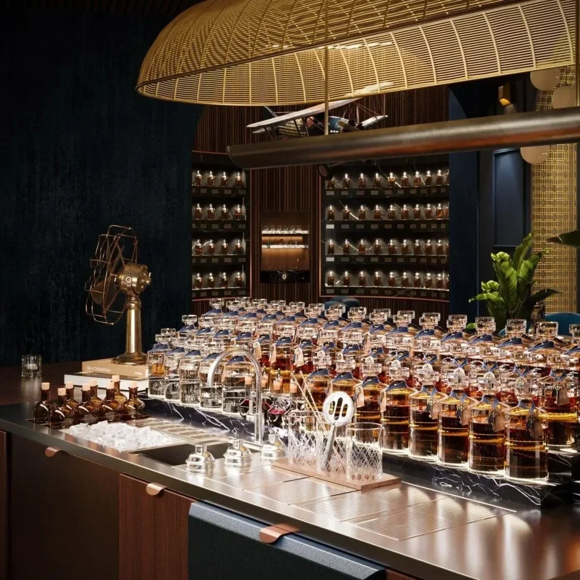 Luxury island bar designed by Studio Numen for Marriott International, featuring leather and wood cabinetry, copper details, a central bottle display, modern cocktail stations, Japanese bar tools and vintage aviation and railway objects.
