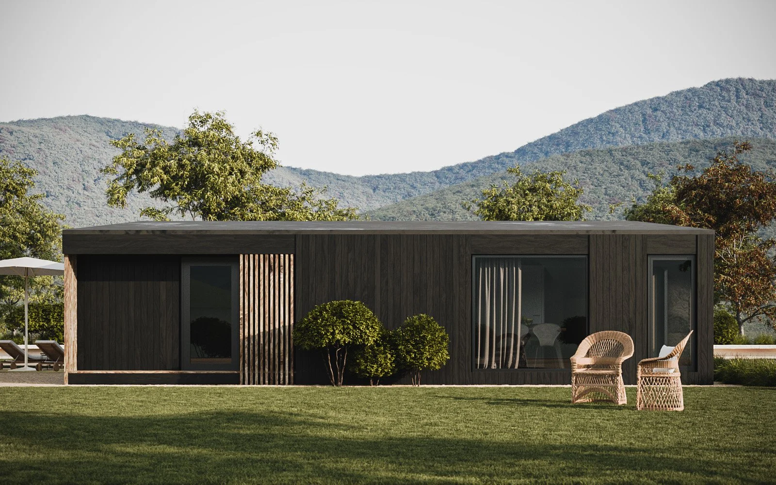 This is the Goldfinch luxury lodge, clad in black and shown in front of a grass lawn