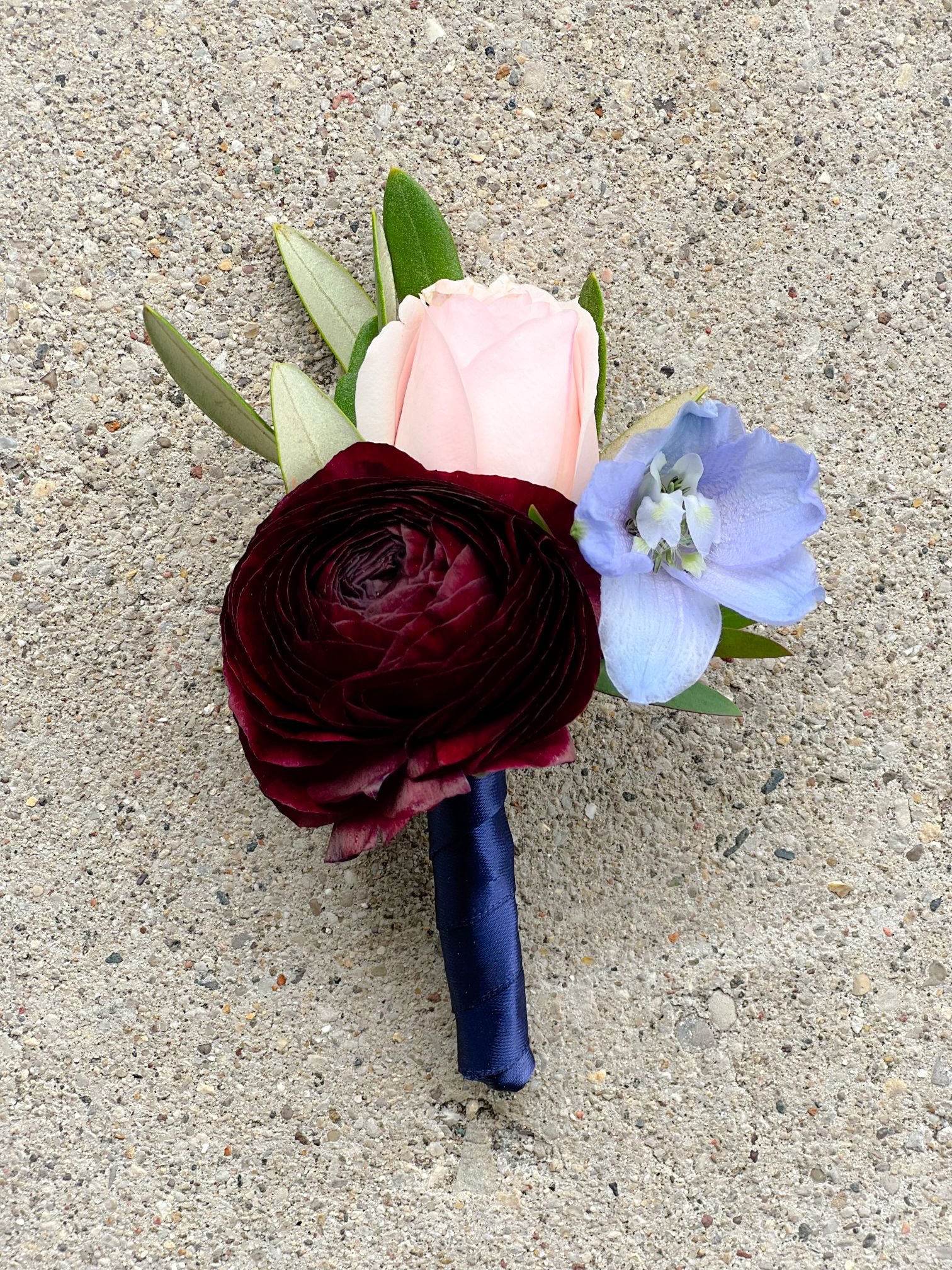 Plum ranunculus delphinium boutonniere.jpg