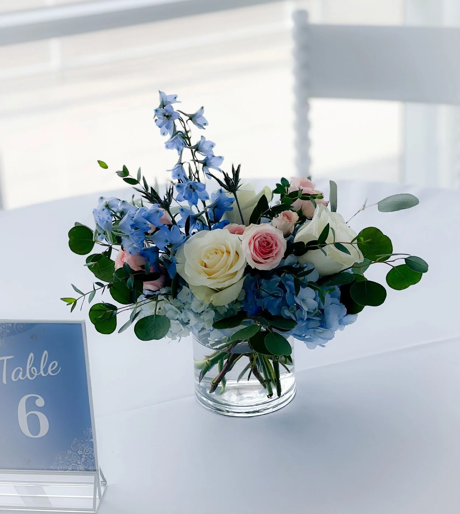 Cylinder delphinium rose hydrangea euc centerpiece.jpg