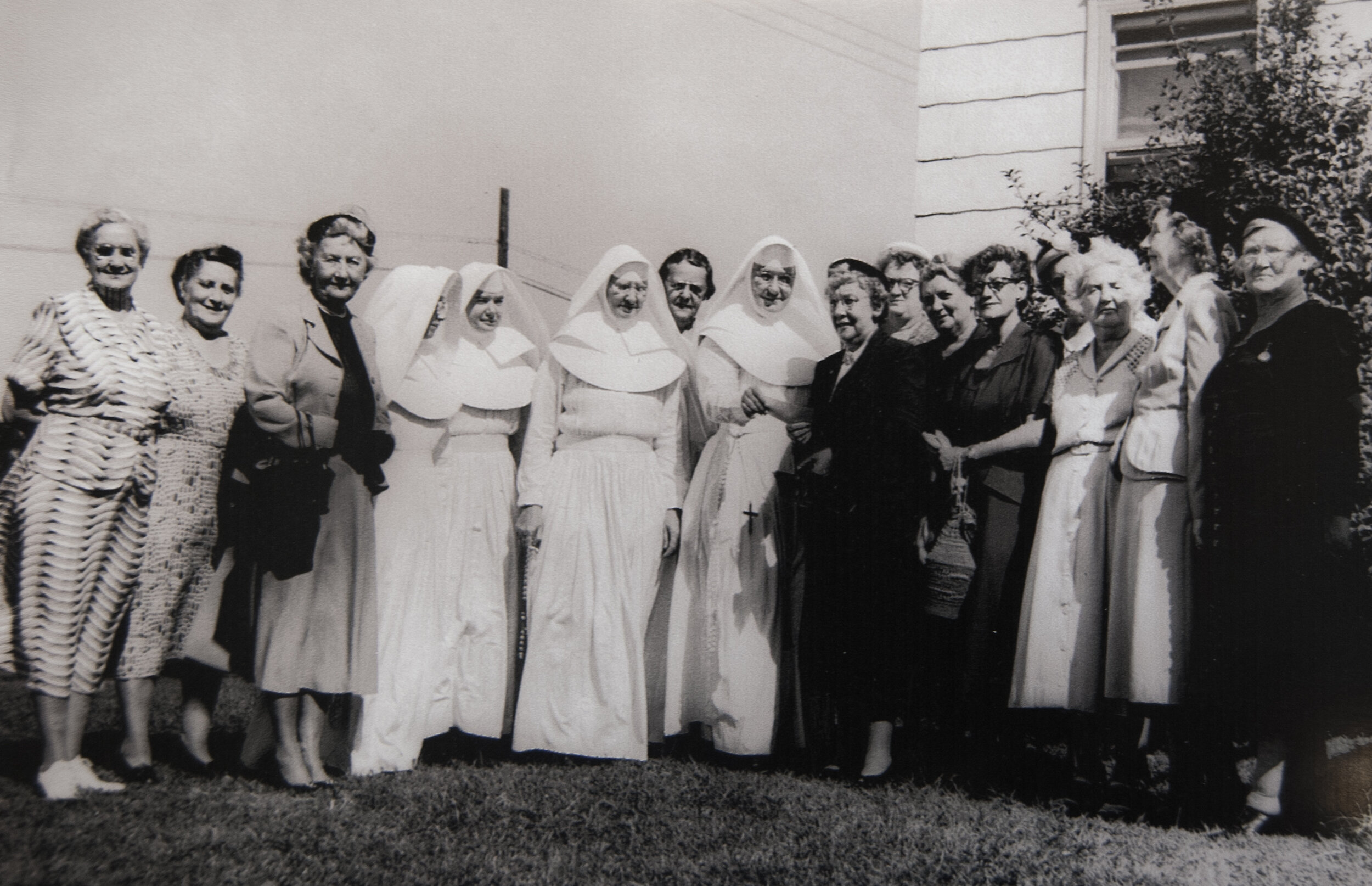 Margaret Ryan, president of the Mercy Hospital Auxiliary, presents a check to the Sisters of Mercy for the establishment of a blood bank, Sept. 20, 1953.