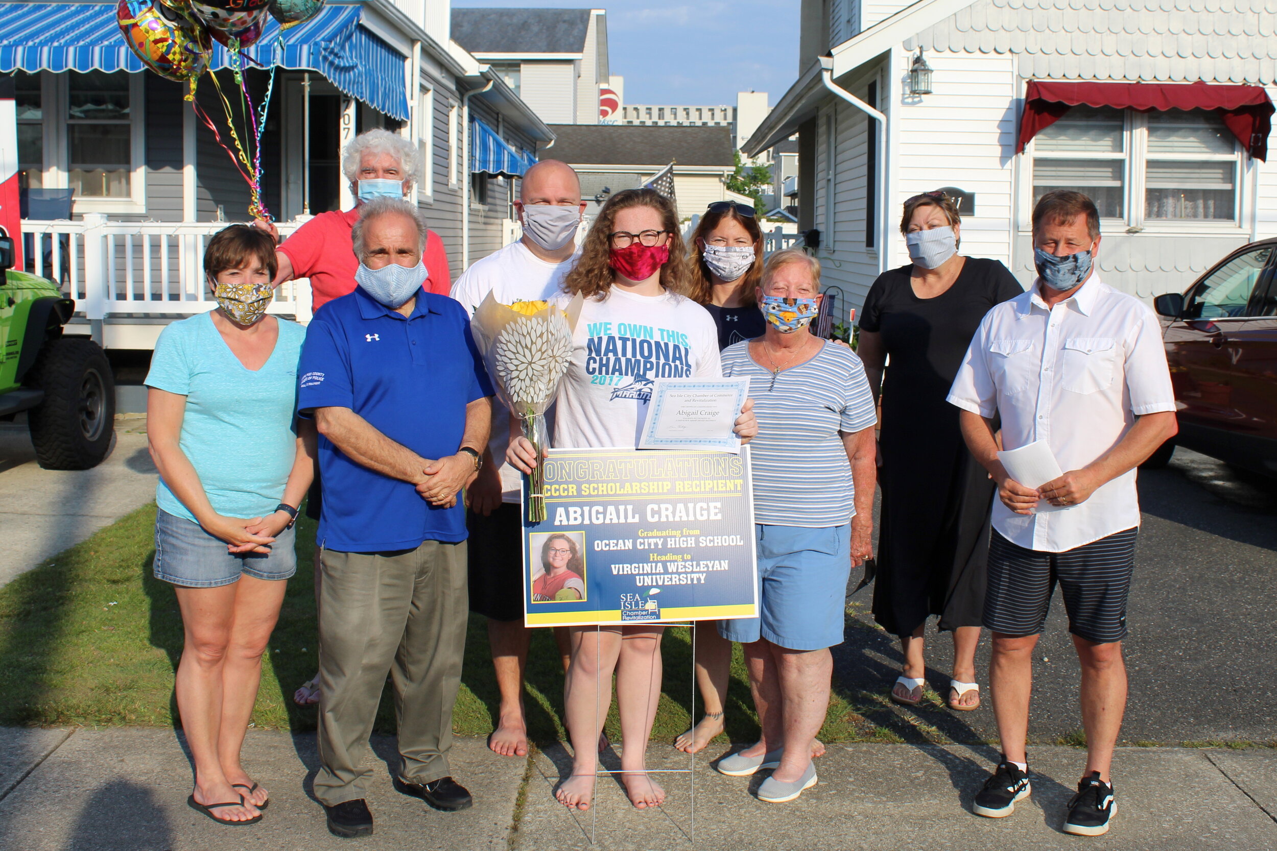  Abigail Craige poses with sign designating her as a recipient of a scholarship from the Sea Isle City Chamber of Commerce and Revitalization. She is surrounded by family members as well as Mayor Leonard Desiderio, SICCCR president Brian Heritage and