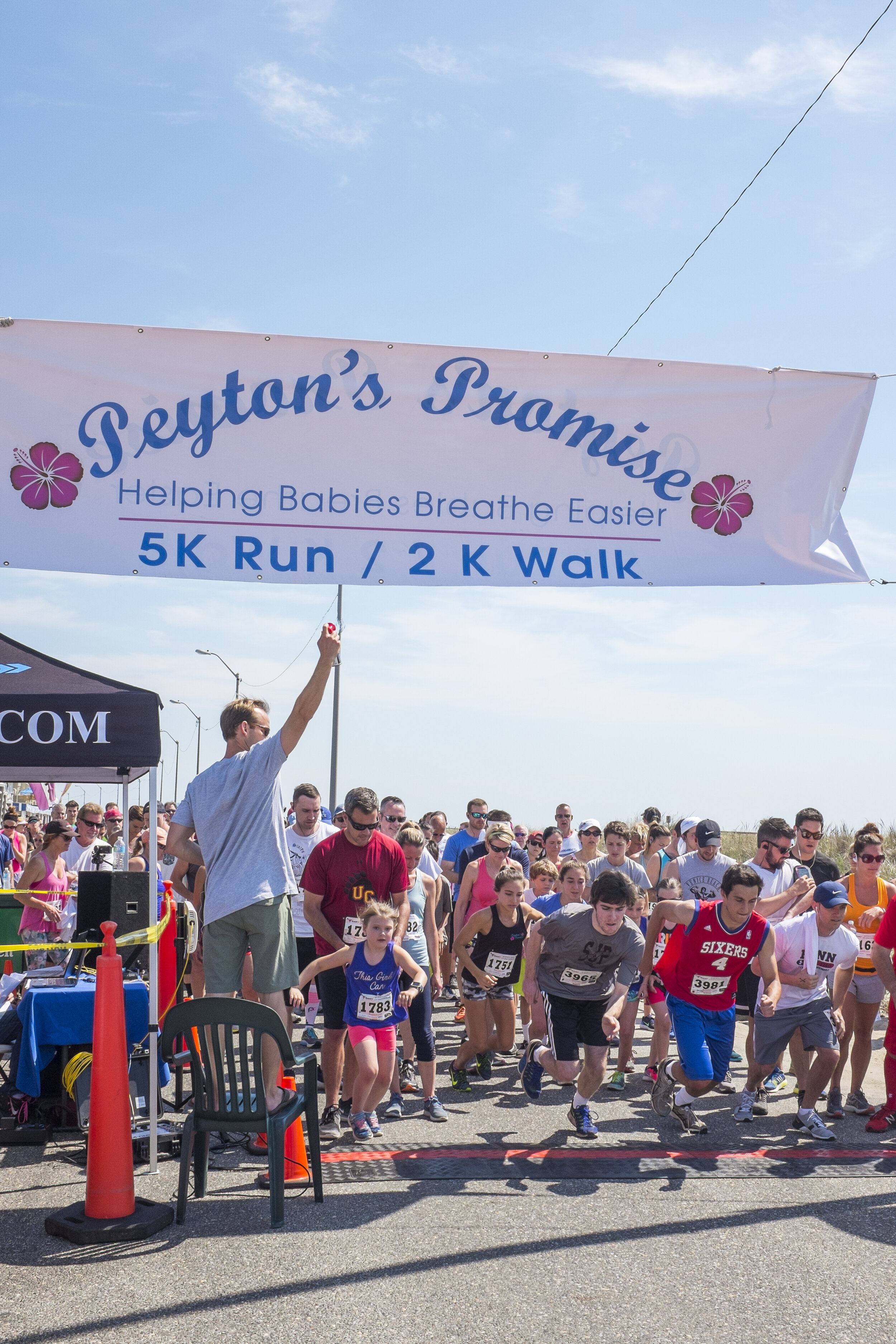 Peyton’s dad signaling the start of the Peyton’s Promise 5K Run last summer on the Promenade. 