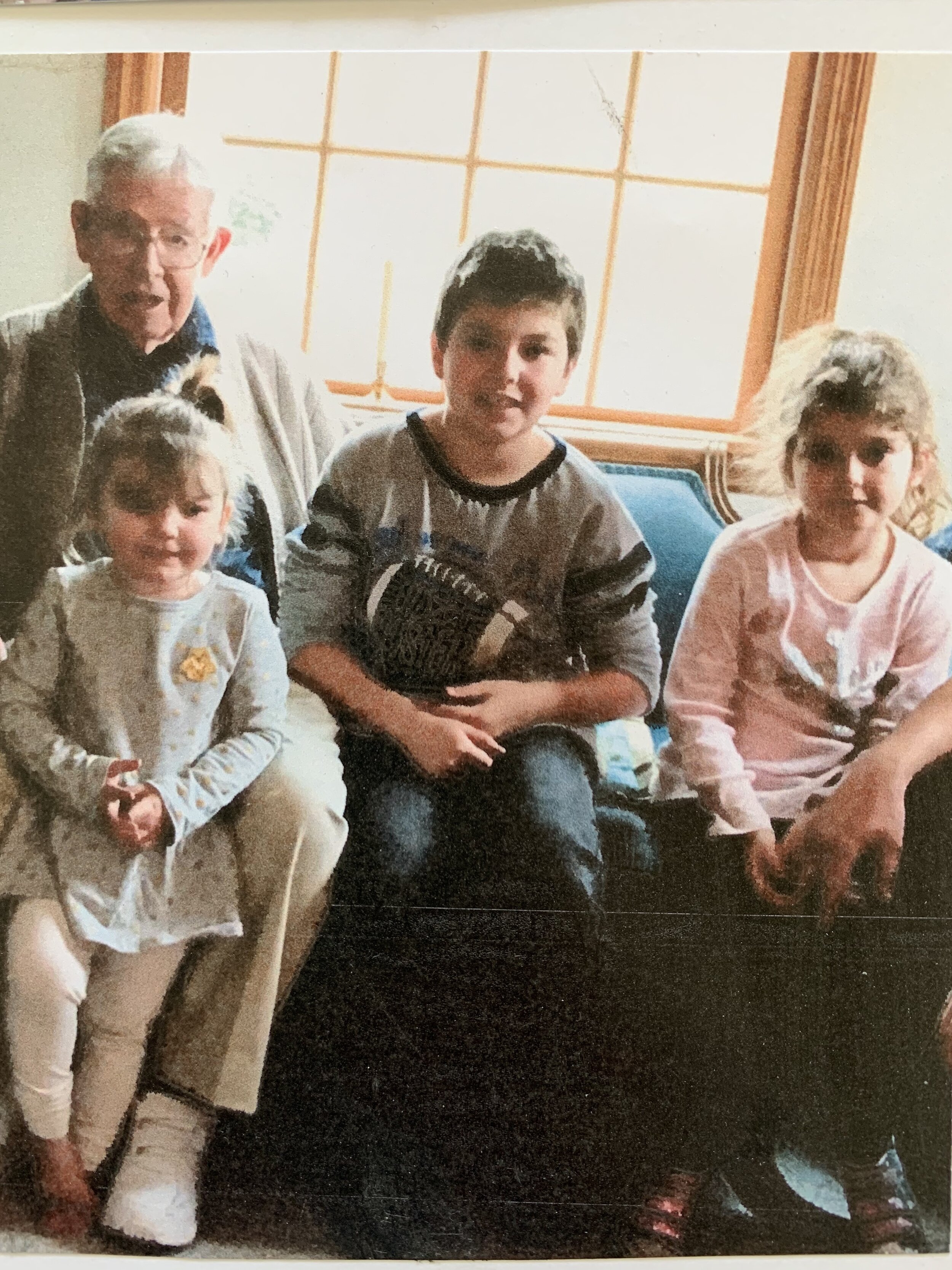 Mike with his great-grandchildren, Marie, Dylan and Camryn. 