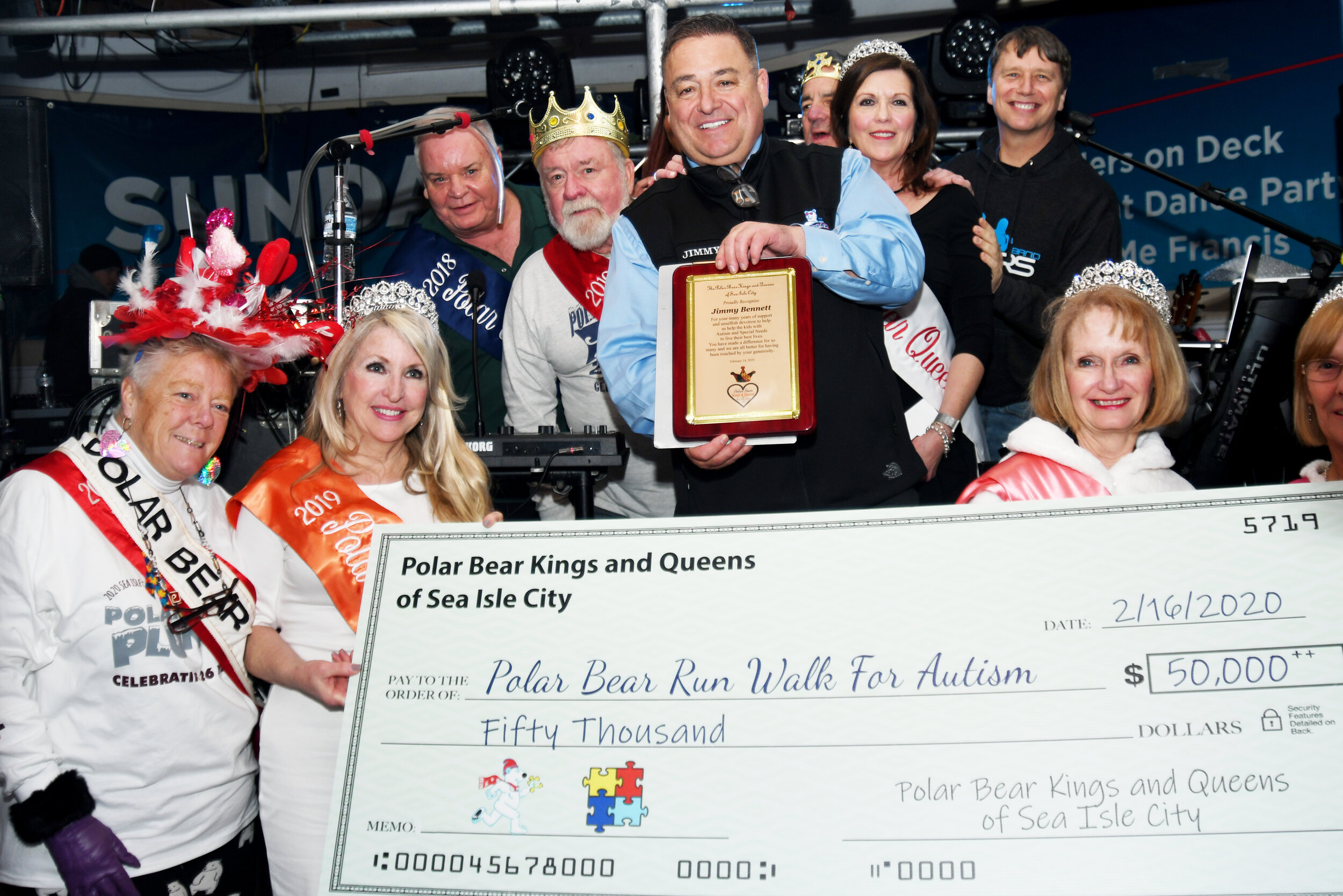 The Polar Bear Kings and Queens presented La Costa owner Jimmy Bennett with a plaque and unveiled their $50,000 donation to the Polar Bear Run/Walk for Autism.