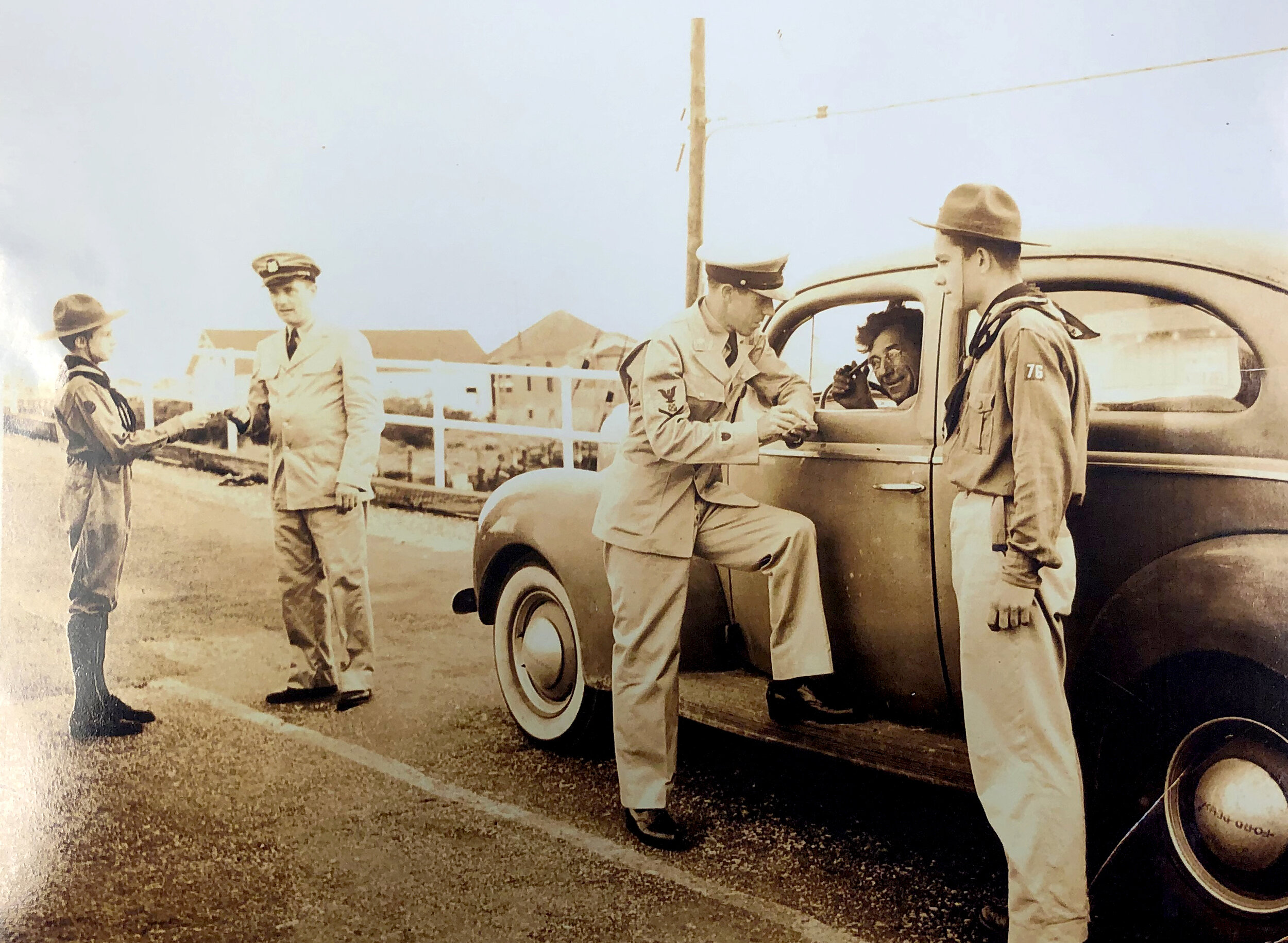 All vehicles stopped to verify residency before entering town. From left, Boy Scout Mike Davies, Coast Guard officer Carl Lovejoy, Gus Bolt in his car and Scout Herman Fehrle. 