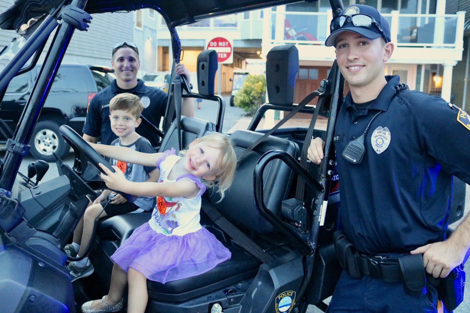 Bryce Keppler and Ella VanderNeut with Officers Kyle Lawrence and Jeffrey Snyder at National Night Out.