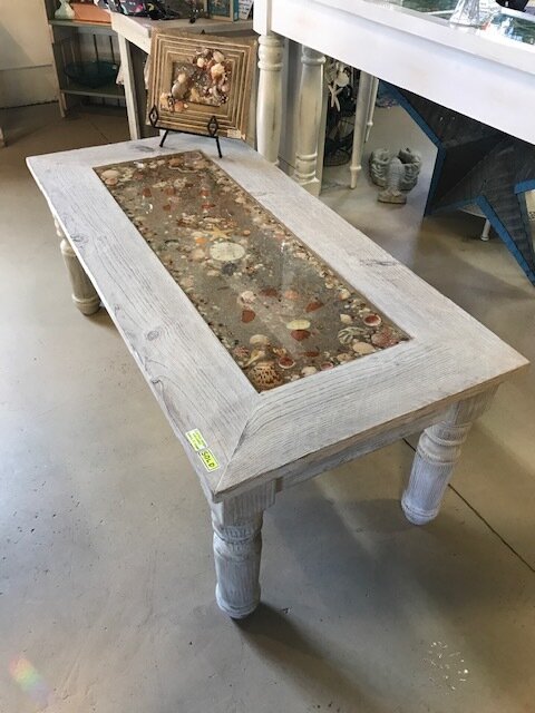 An old wooden table that Waywell repurposed into art in her sea-life mosaic collection. 