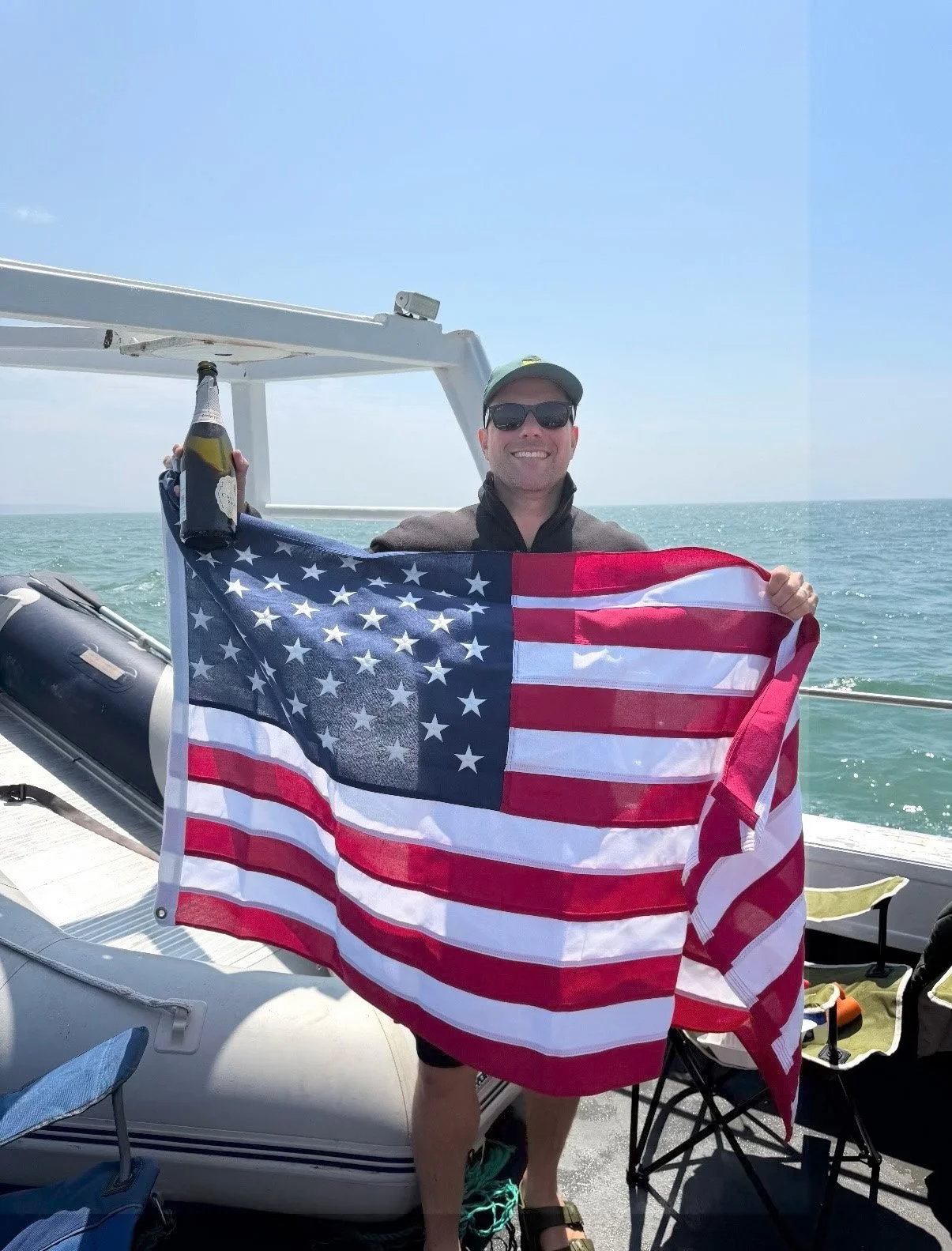 Joe Chiarantona with the American flag when they  returned to England after the swim.