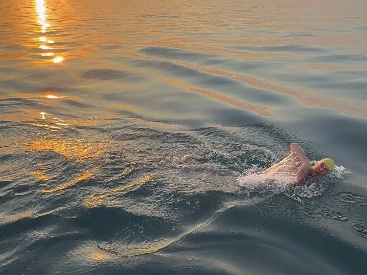 Joe Chiarantona swimming mid-channel at sunrise.