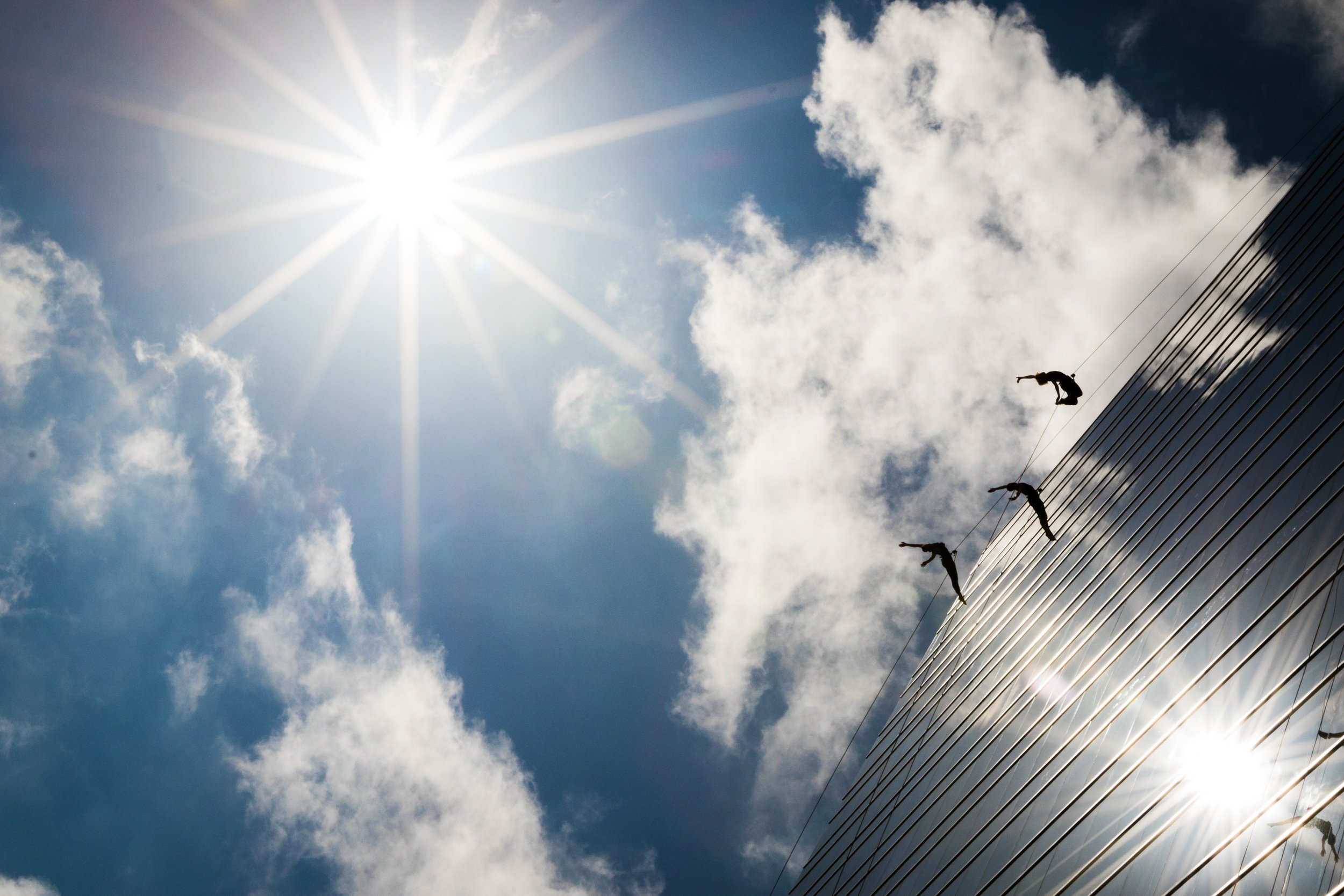 Bandaloop, an aerial dance company, performs vertically on a high rise building.