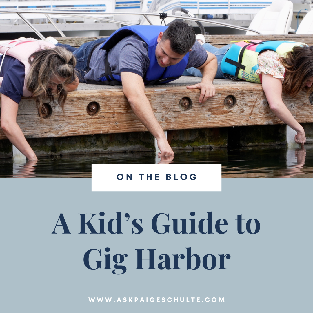 Blog title image with text "A Kid’s Guide to Gig Harbor" and image above of Paige, Falynn and Joel dipping hands into lake of Gig Harbor while exploring the area..