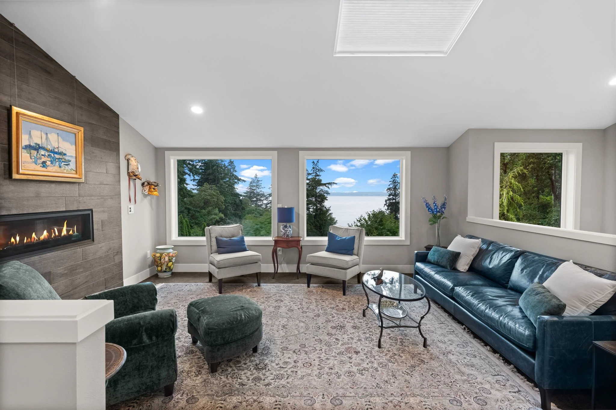 Interior view of Gig Harbor waterfront luxury home with sound view through floor-to-ceiling windows