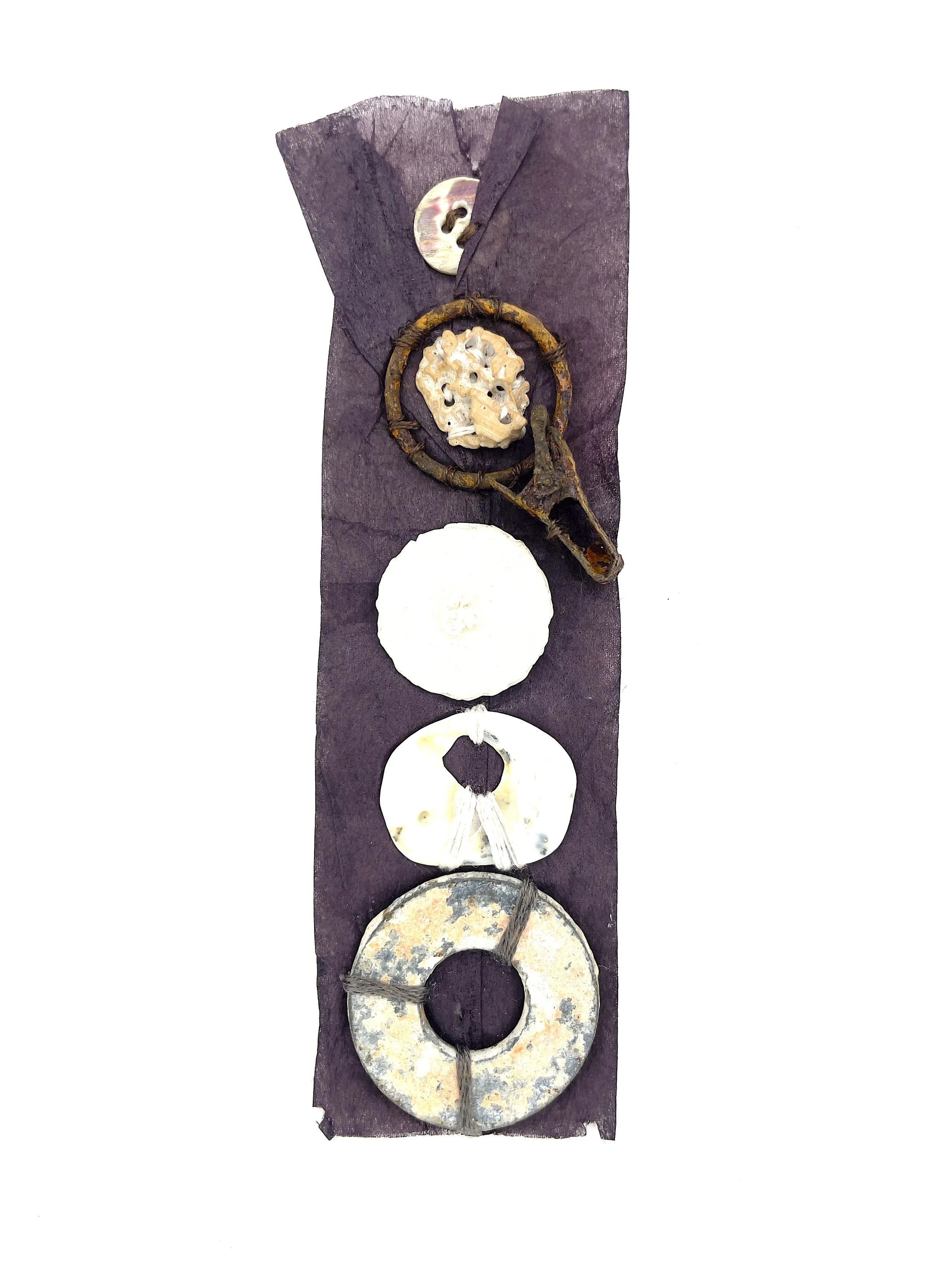 Marking Time 86 , 2023, shell, rusty metal, sand dollar, button, thread, oak gall ink dyed teabag, 5.75 x 1.75 inches (unframed), 11.25 x 9.25 inches (framed), $475. (framed)