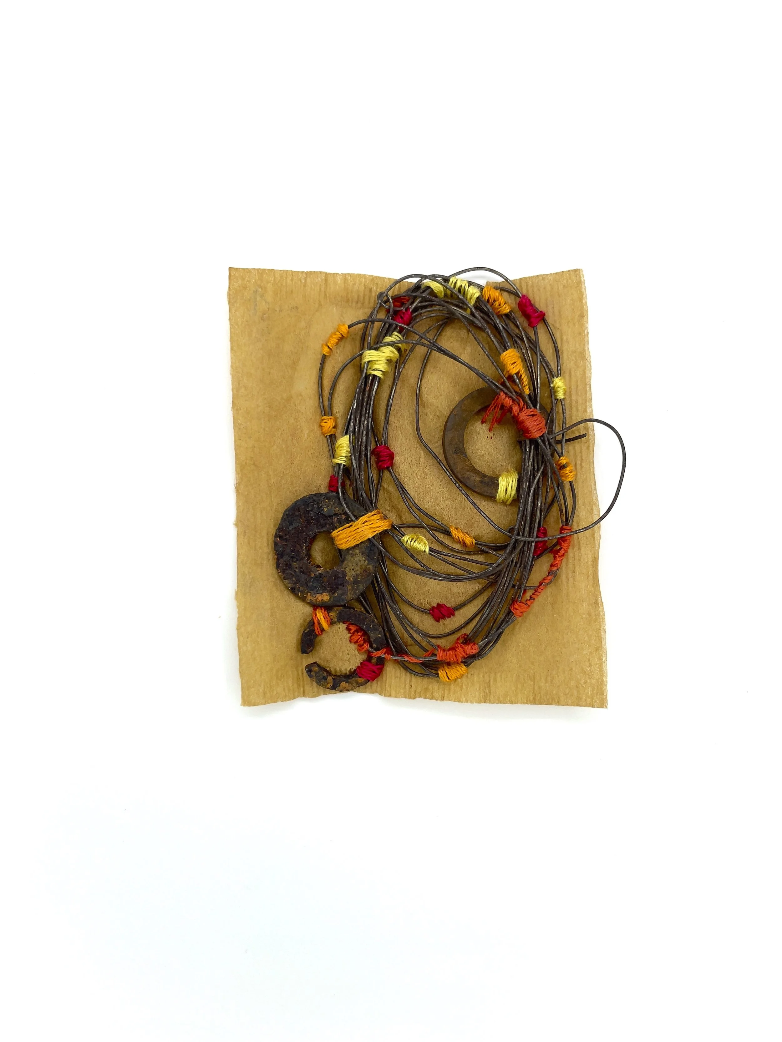 Marking Time 94 , 2023, rusted wire, rusted metal, thread, sunflower ink stained teabag, 3 x 2.75 inches (unframed), 11.25 x 9.25 inches (framed), $475. (framed)