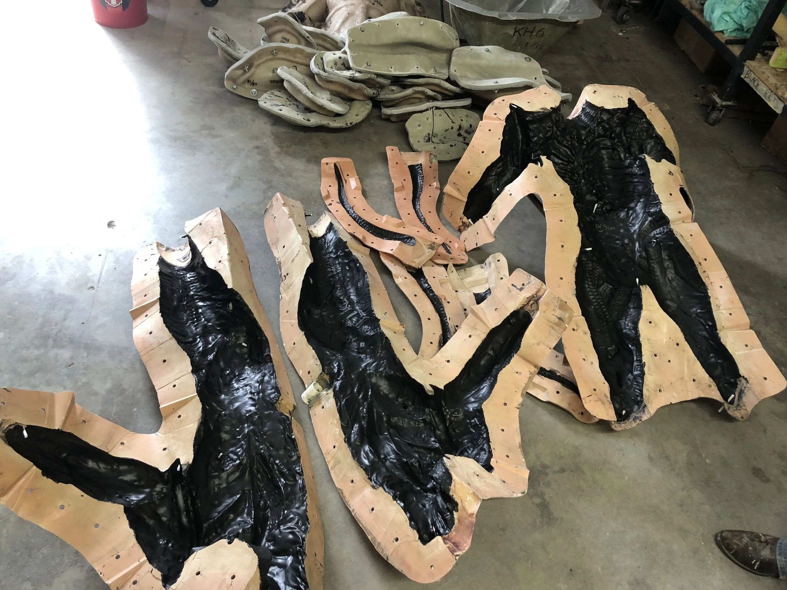 foam latex detail layer brushed into the body mold and baked before it is closed over the body form and injected