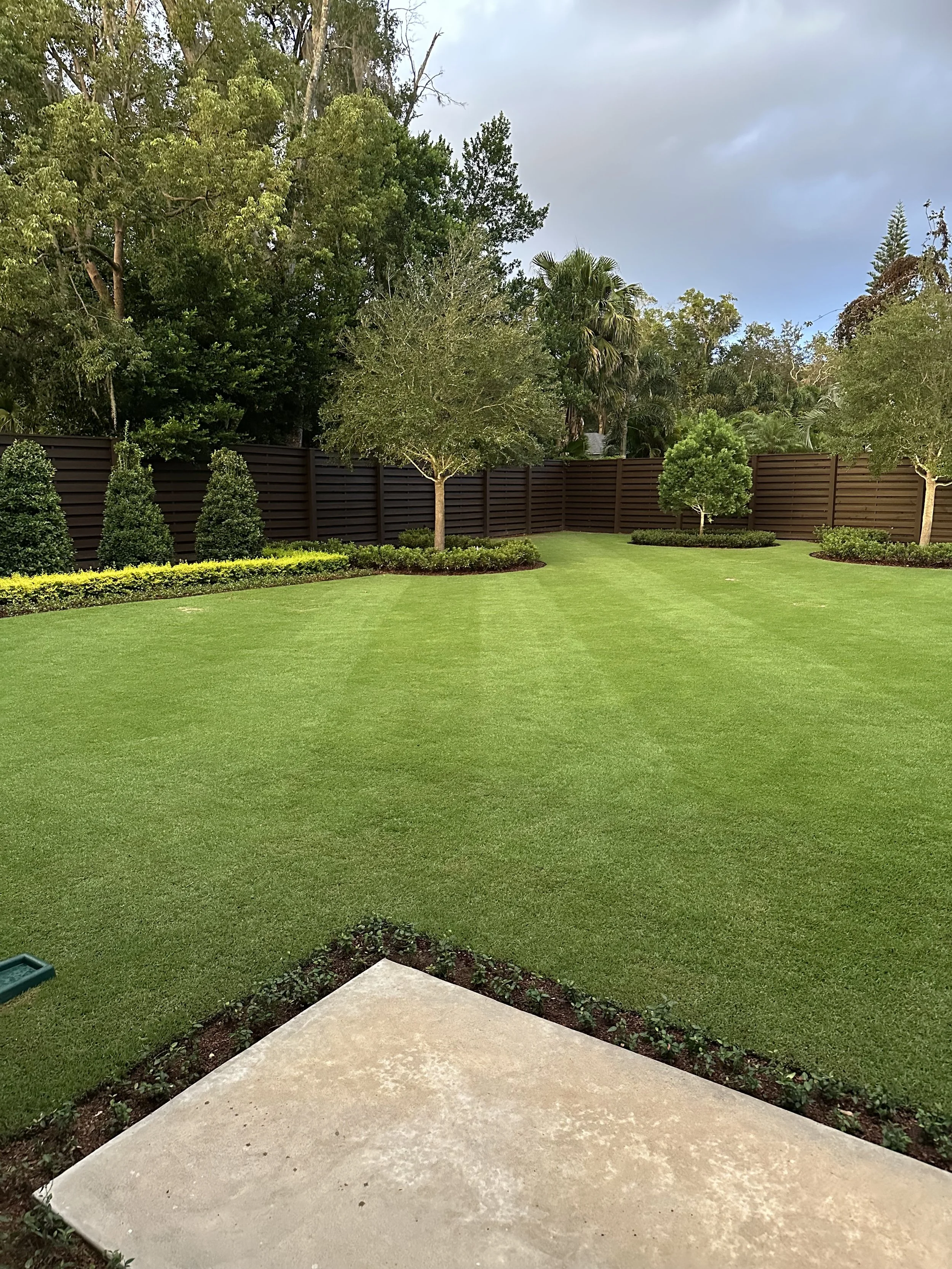 Lake Mary estate with professionally landscaped front yard and Zoysia turf