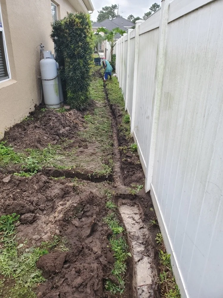French drain trench dug along a side yard fence in Maitland FL