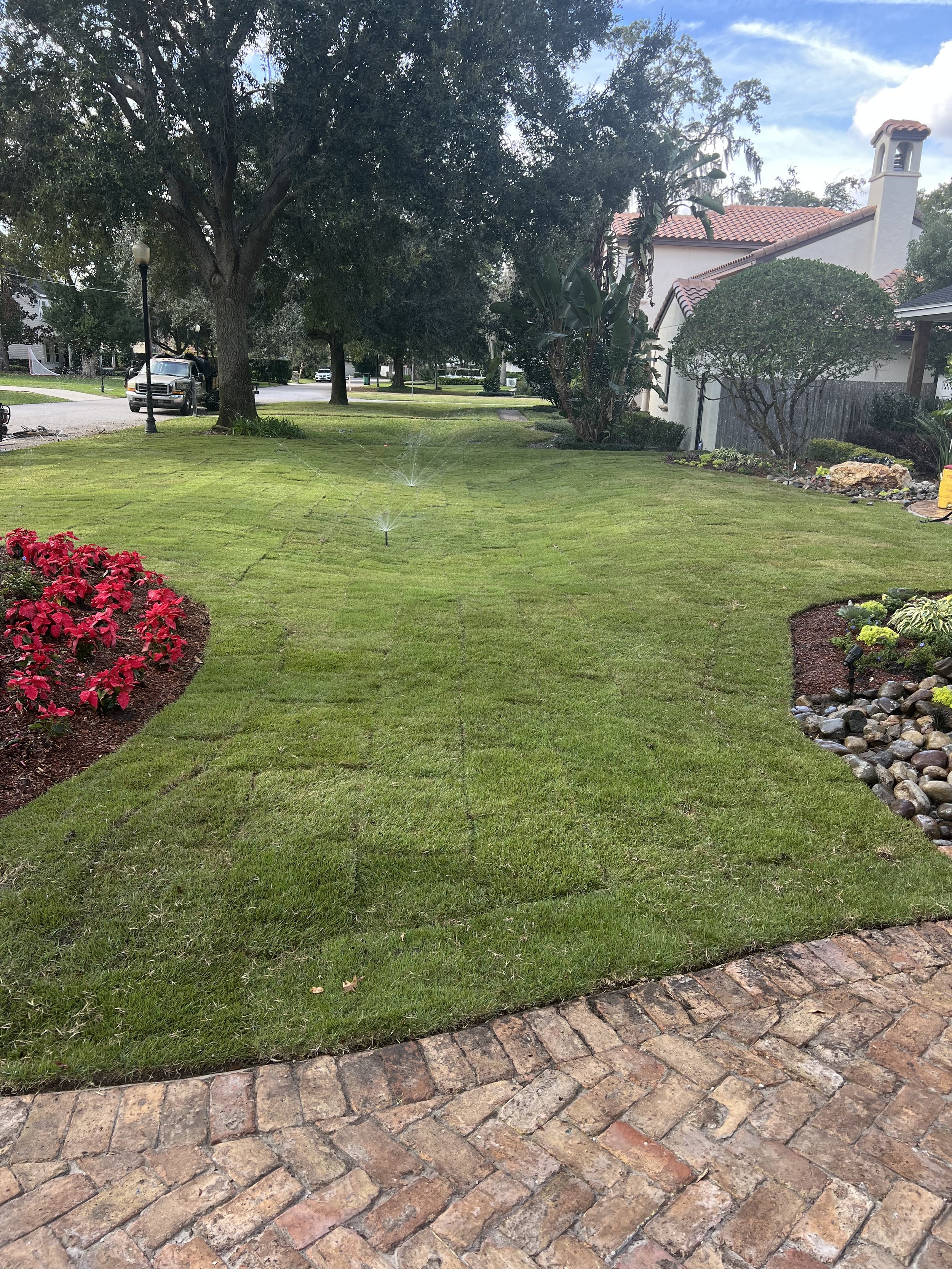 WInter Park Landscape Installation and renovation at 1411 Place Picardy including CitraZoy Zoysia Sod Installation which is watered by a irrigation make over that includes conversion over to Hunter MPR's .   RockBed Landscape Make over . All work com